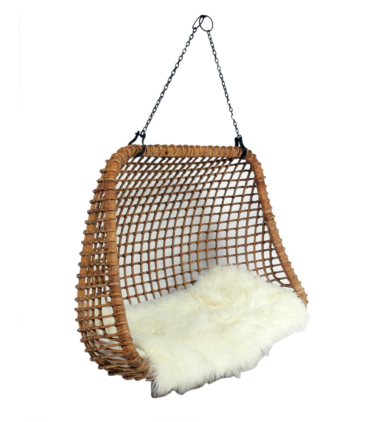 Hanging Rattan Settee, circa 1960s. We have seen plenty of the hanging rattan chairs, but have never seen a hanging rattan settee. This would be equally at home indoors or on a covered porch. Great piece for indoor or outdoor living. It has been