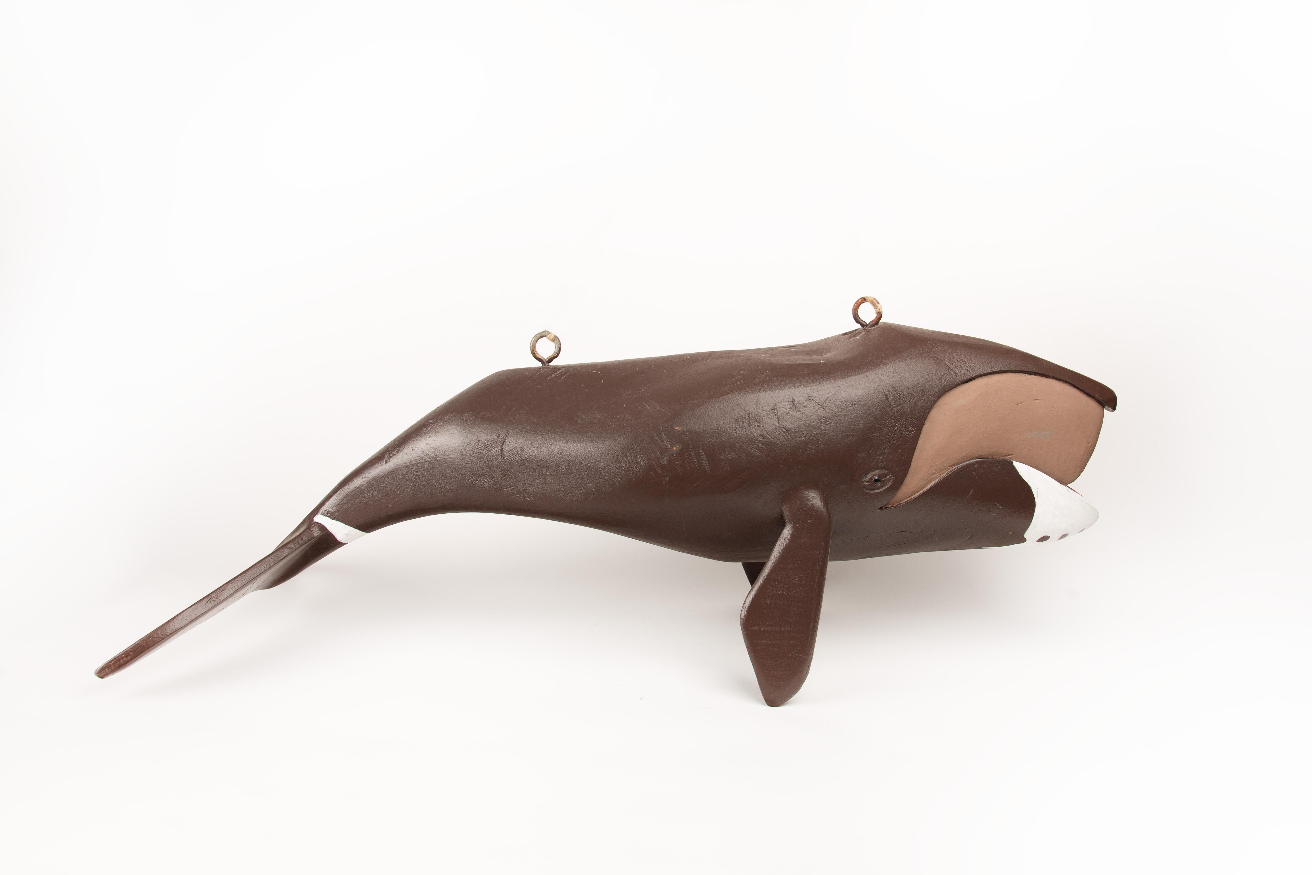 This large hand-carved and painted wooden Right Whale sculpture is by  Jeff Raymond (1949–2022) of Poughkeepsie and Red Hook, NY, a self-taught folk artist known for his lifelong fascination with marine life, particularly whales and Hudson River