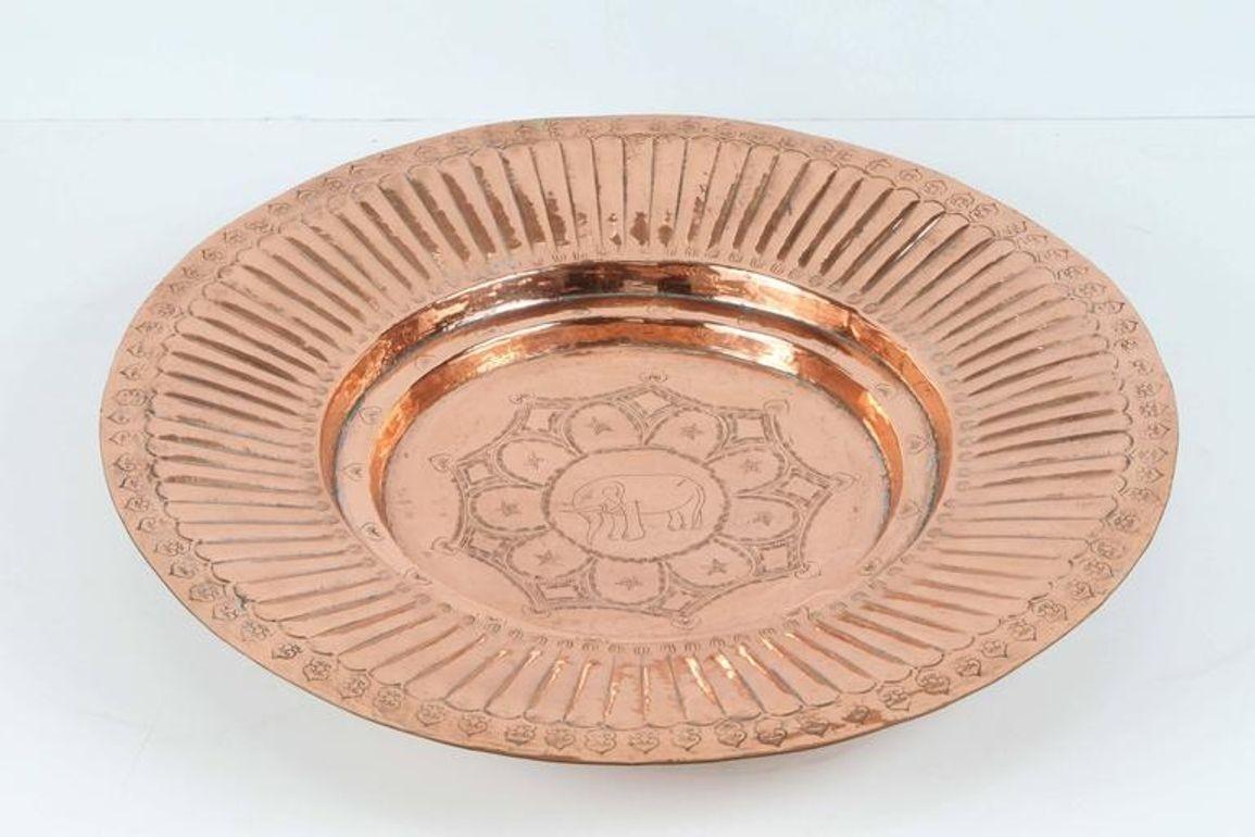 Antique 1940s Asian polished round copper tray, hand-hammered with geometric design and an elephant in the center,
 The elephant symbol in the Asian culture means protection and long life.
Dimensions: 20.5 in. Diameter x 3 in. 
Has a hook in the