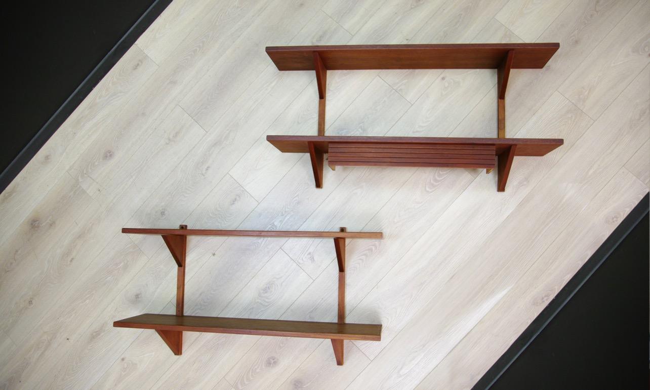Original hanging shelves from the 1960s-1970s, minimalist Danish design. Finished with teak veneer, one of the shelves has lighting. Preserved in good condition (small bruises and scratches, filled veneer loss, lighting not checked) - directly for