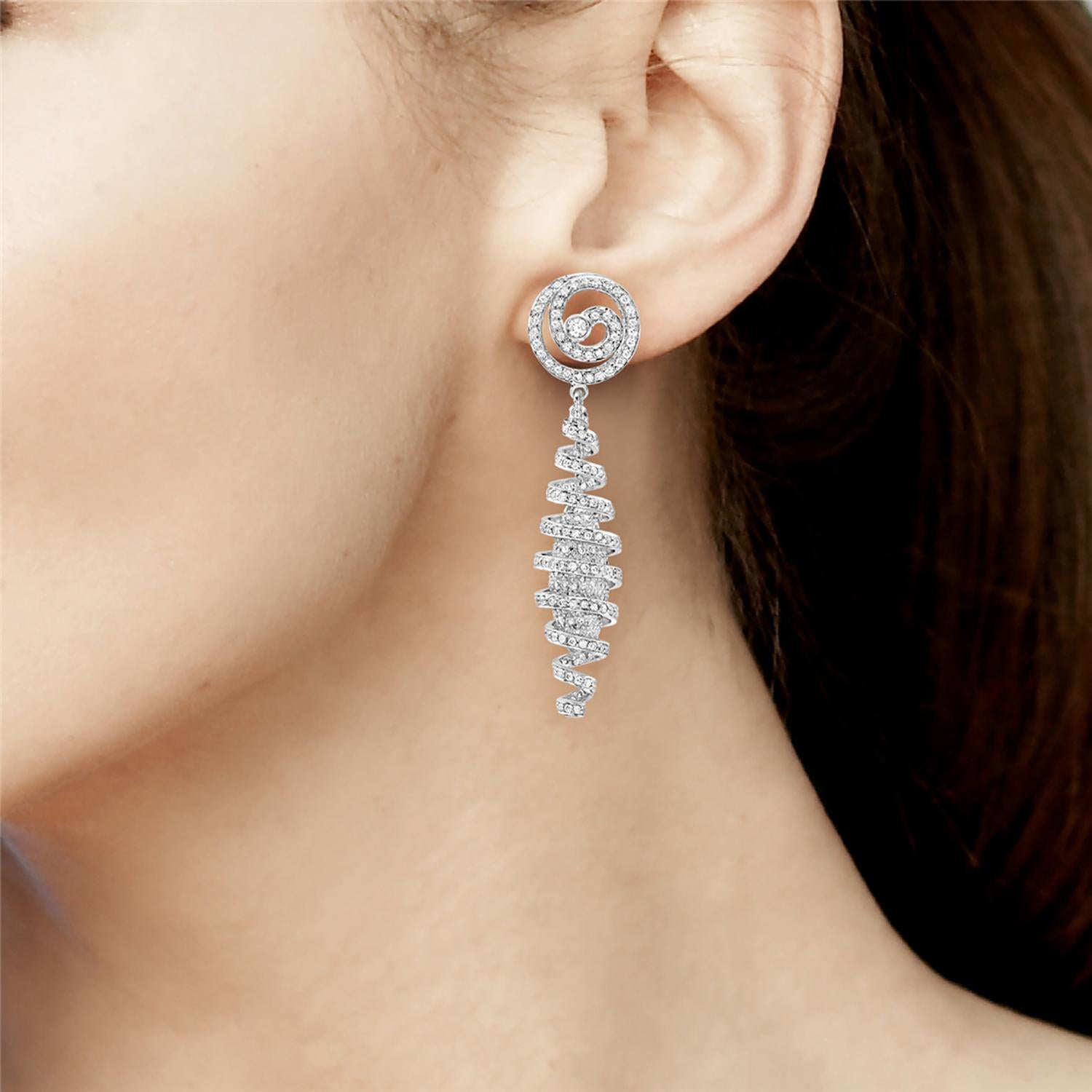 These exquisite earrings feature a hanging swirl shape crafted from lustrous 18k white gold. A stunning halo of pave diamonds encircles each earring, adding brilliant sparkle and elegance to any outfit. Perfect for special occasions or as a dazzling