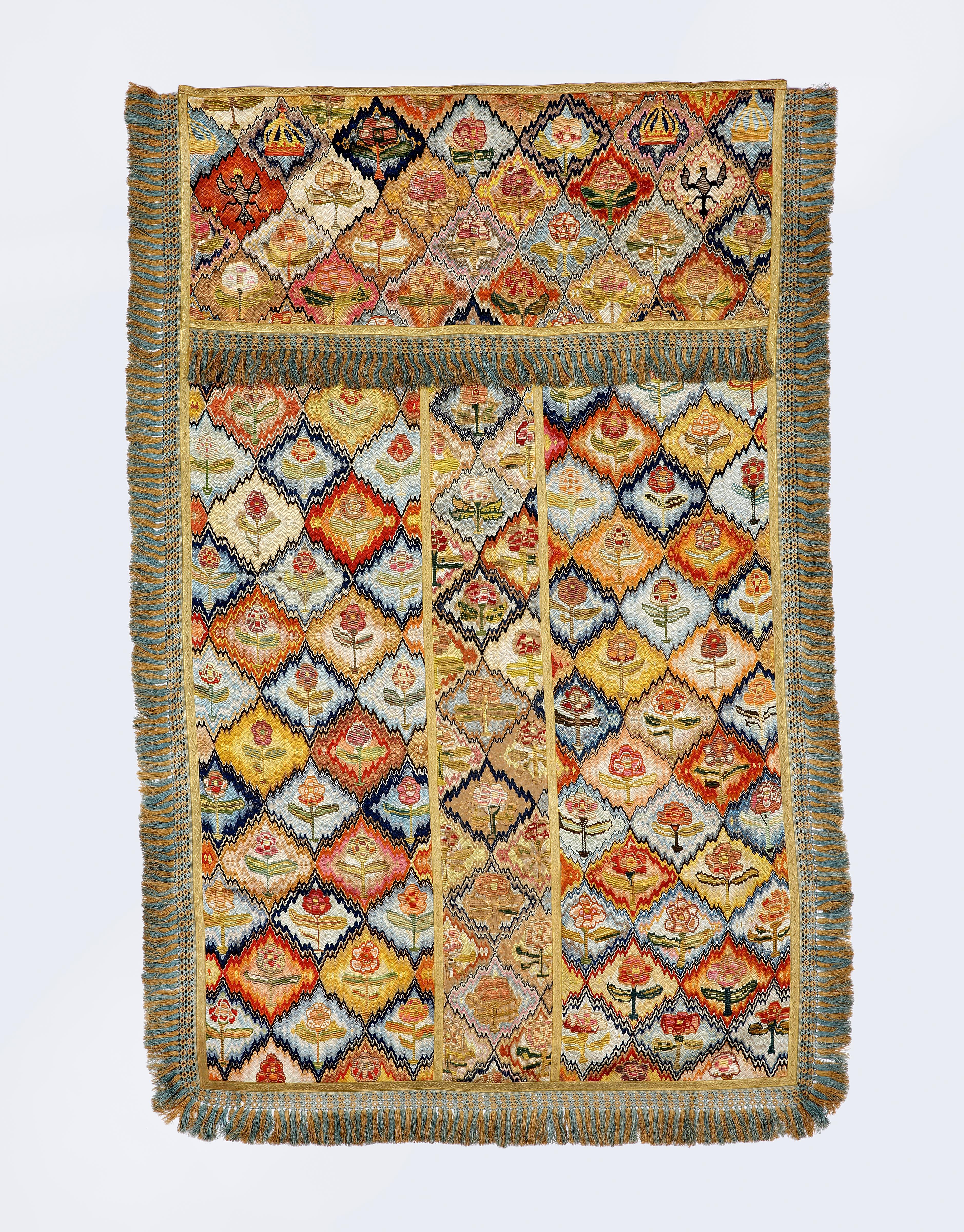 Rare 19th century Italian Bargello hanging or coverlet with armorial and floral medallions

Worked in Florentine stitch in a brilliant palette with diamond shape trellised medallions with two crowns and an eagle in each top corner and stylized