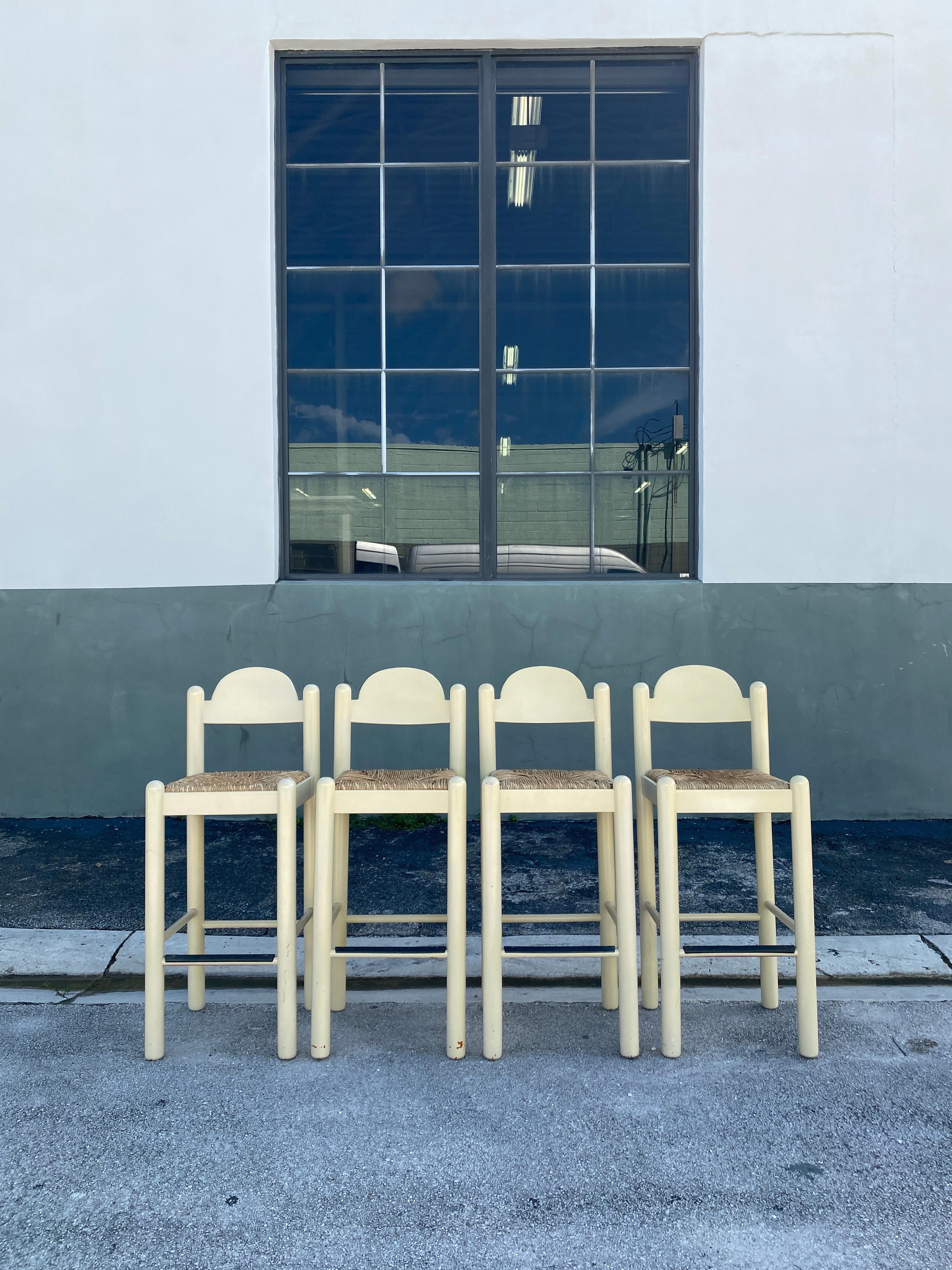 Post-Modern Hank Lowenstein's Oggo Pavoda barstools in warm-white wood with rush seats