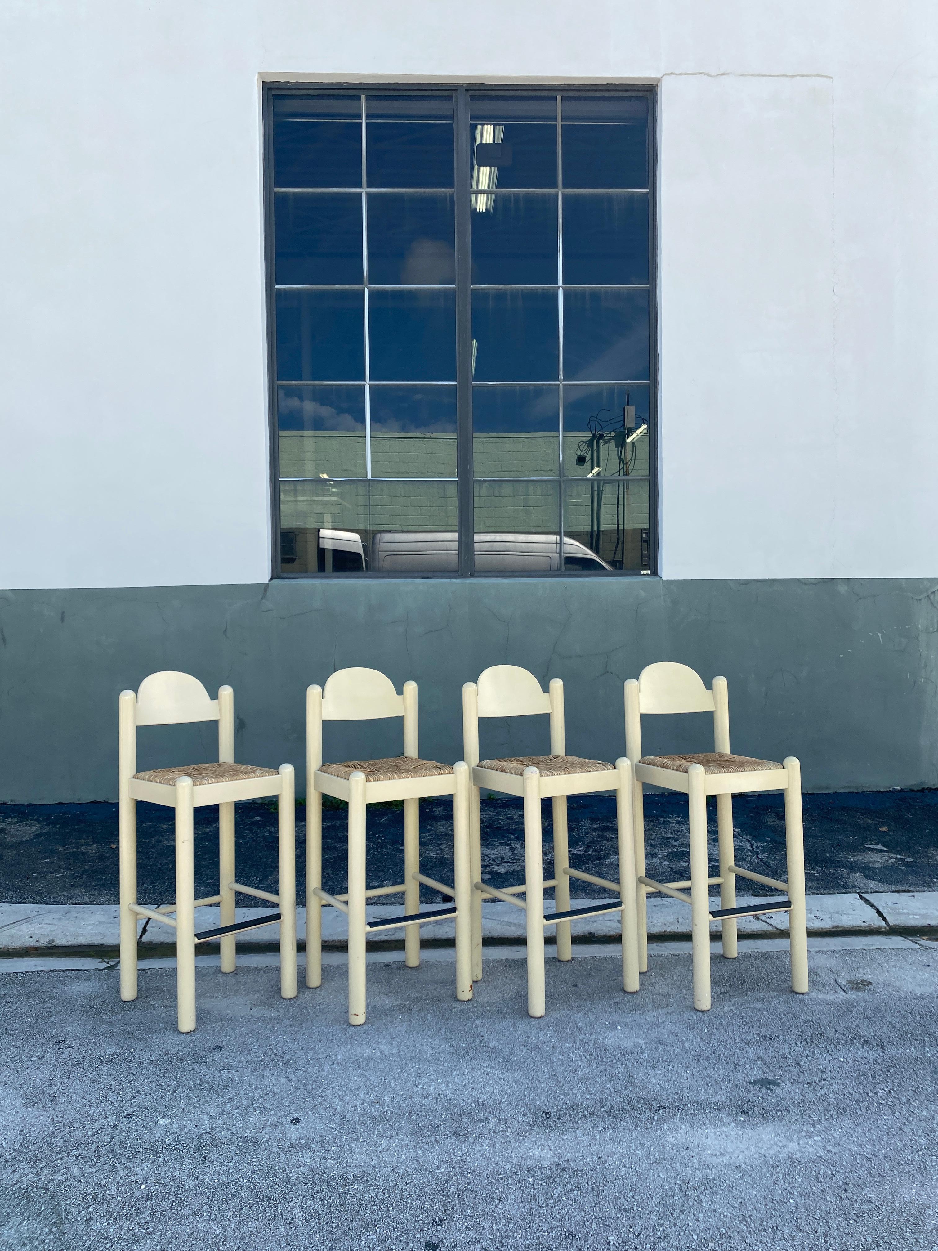 Italian Hank Lowenstein's Oggo Pavoda barstools in warm-white wood with rush seats