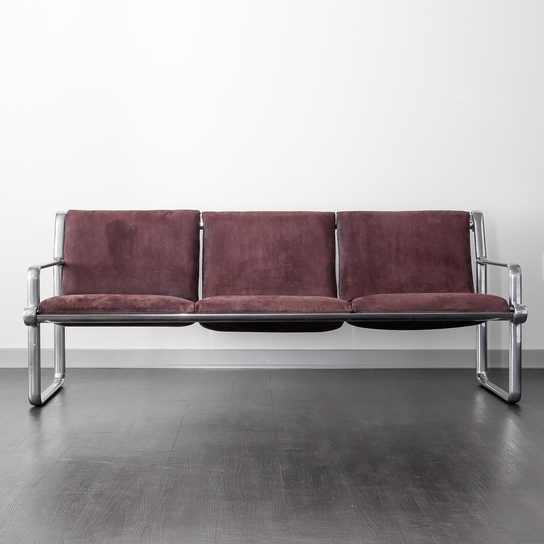 Open arm three-seat sofa with purple microsuede upholstery designed by Bruce Hannah and Andrew Morrison for Knoll in 1971. The design team worked together at Knoll throughout the 1970s and won numerous design awards. 

Like Marc Newson's Lockheed