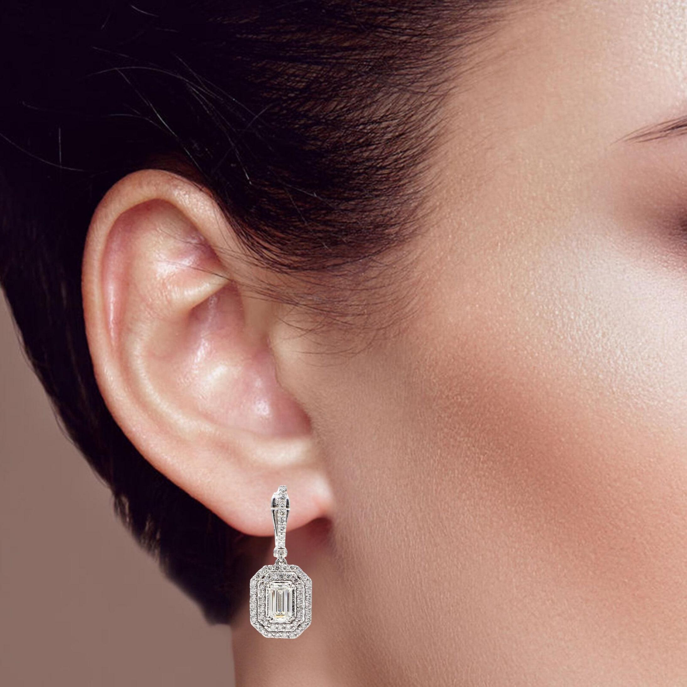 These stunning halo drop earrings feature brilliant round diamonds encased in a sparkling halo setting. Crafted in 14k white gold, their timeless elegance and radiant design make them the perfect accessory for any occasion.

Earring