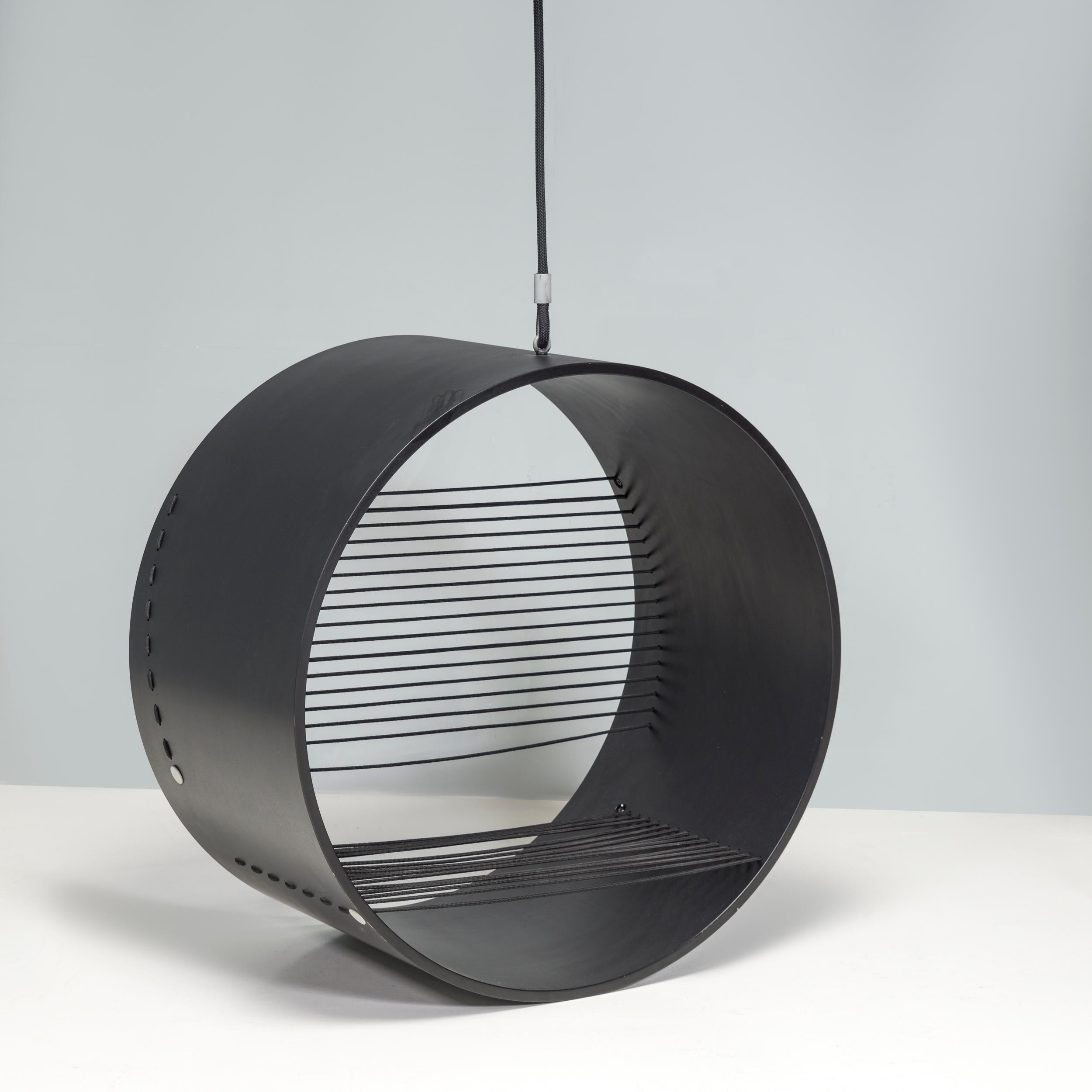 Designed by Danish interior and furniture designer Hanne Kortegaard, the Anello hanging chair is a statement piece.

Constructed from moulded black oak, the large hoop-like shape forms the frame of the seat, which hangs suspended from the ceiling
