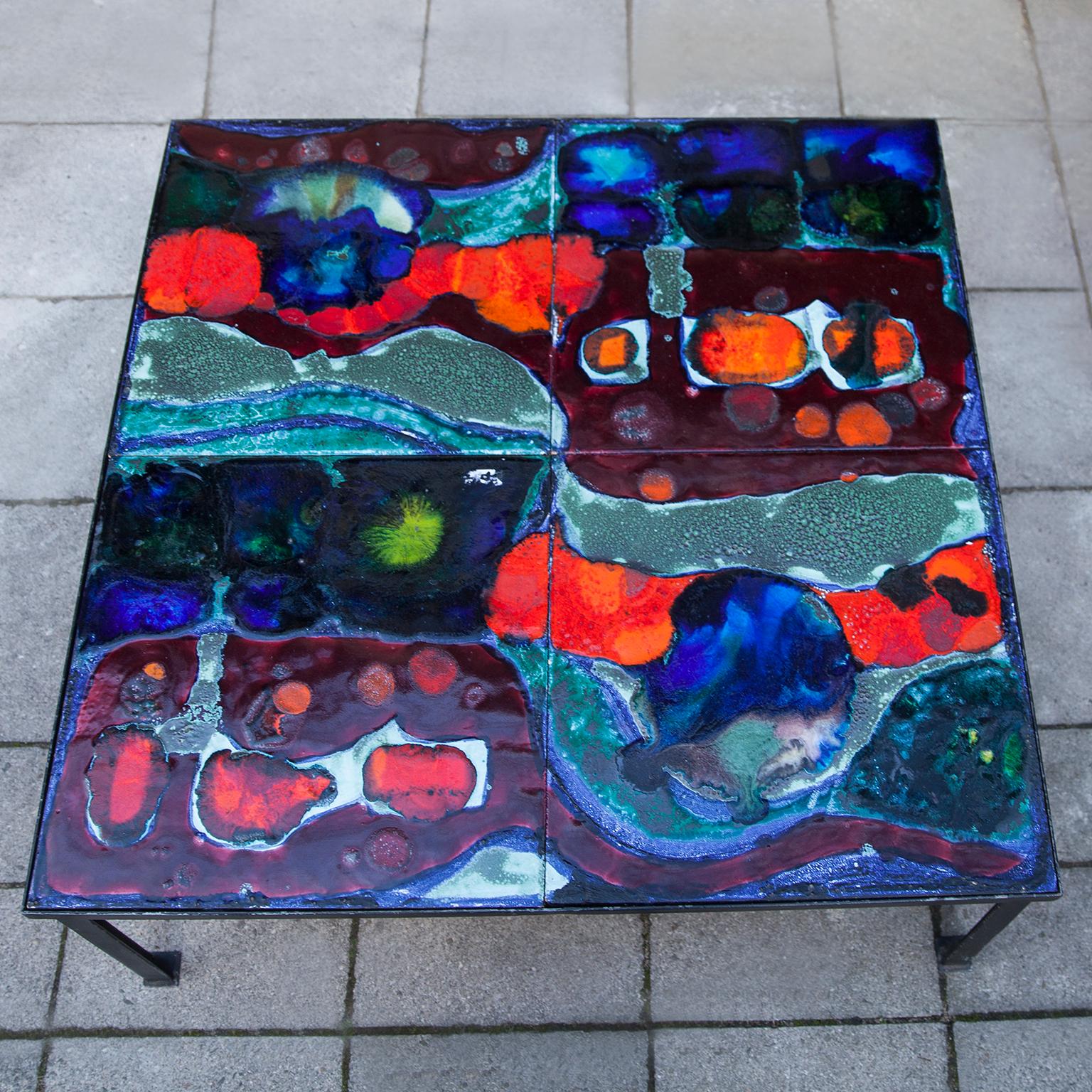 Colorful ceramic coffee table made by Hanns Altmeier, 1906-1979 a German painting artist. Iron black painted base with four ceramic tiles.