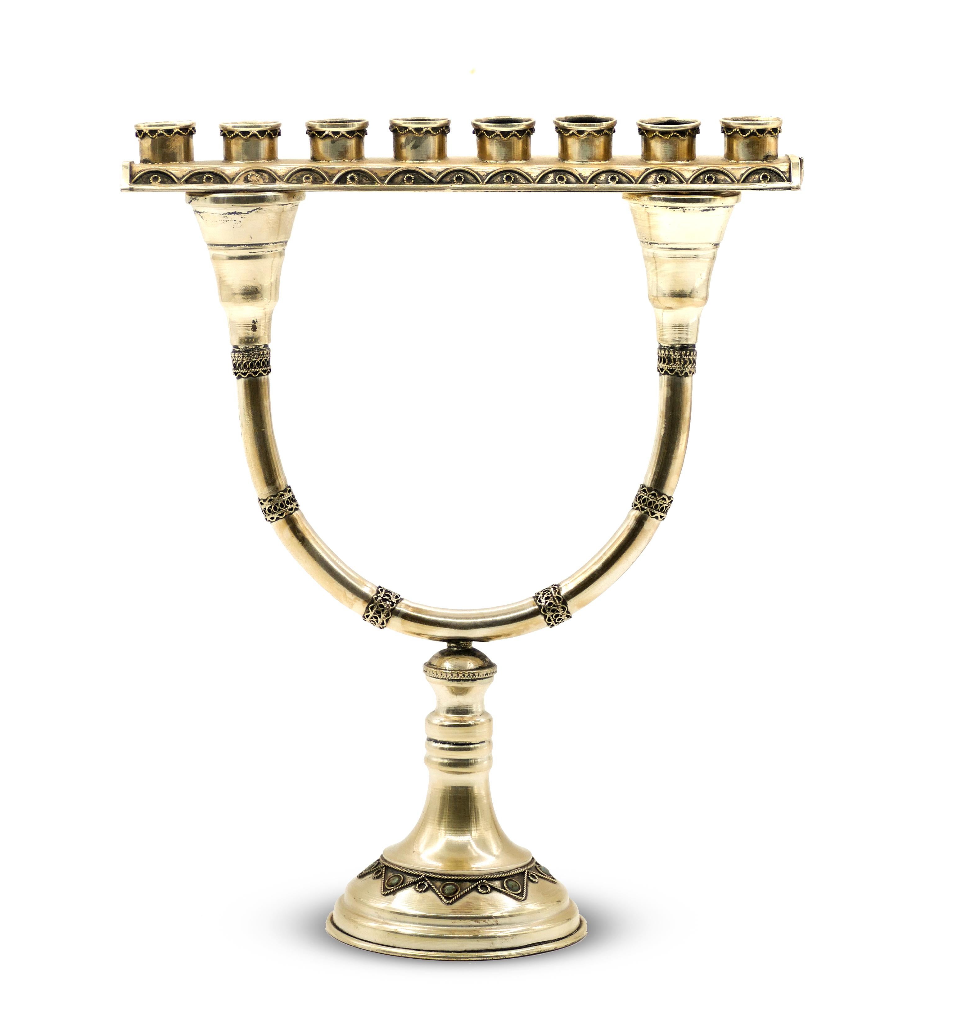This Hannukkah Menorah silver plated candlestick produced in 20th century, is composed by two parts: the base is a two-arm candlestick, on which a straight attachment with eight burners can be fixed.

Simple decorations in silver threads with