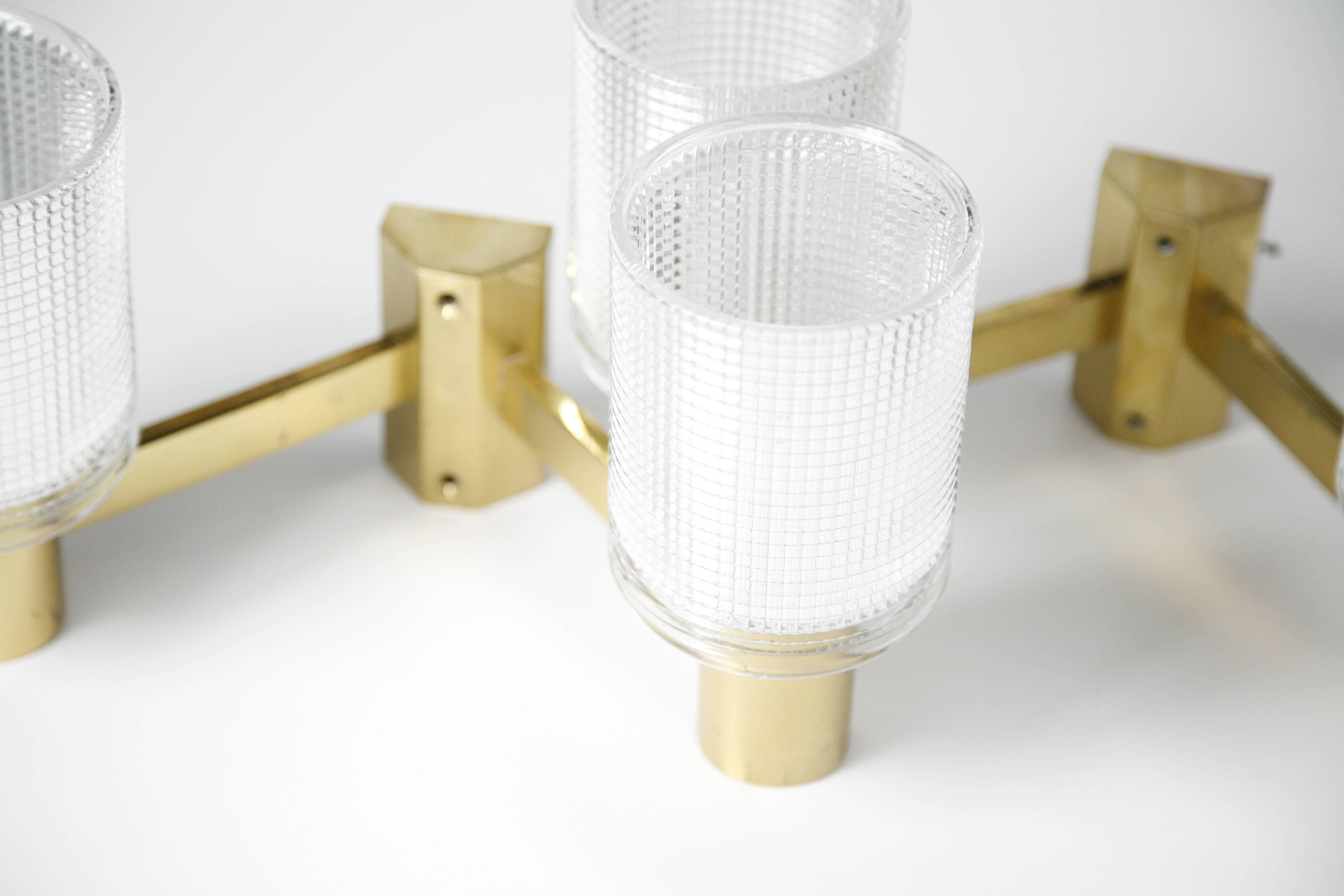 Pair of Swedish wall lights by Hans agne jakobson, Sweden 1970.
Two arm polished brass holding a thick textured round crystal glass shade, one Edison socket in each.
Very modern classy design Hans agne designed and produced all he's lighting, two