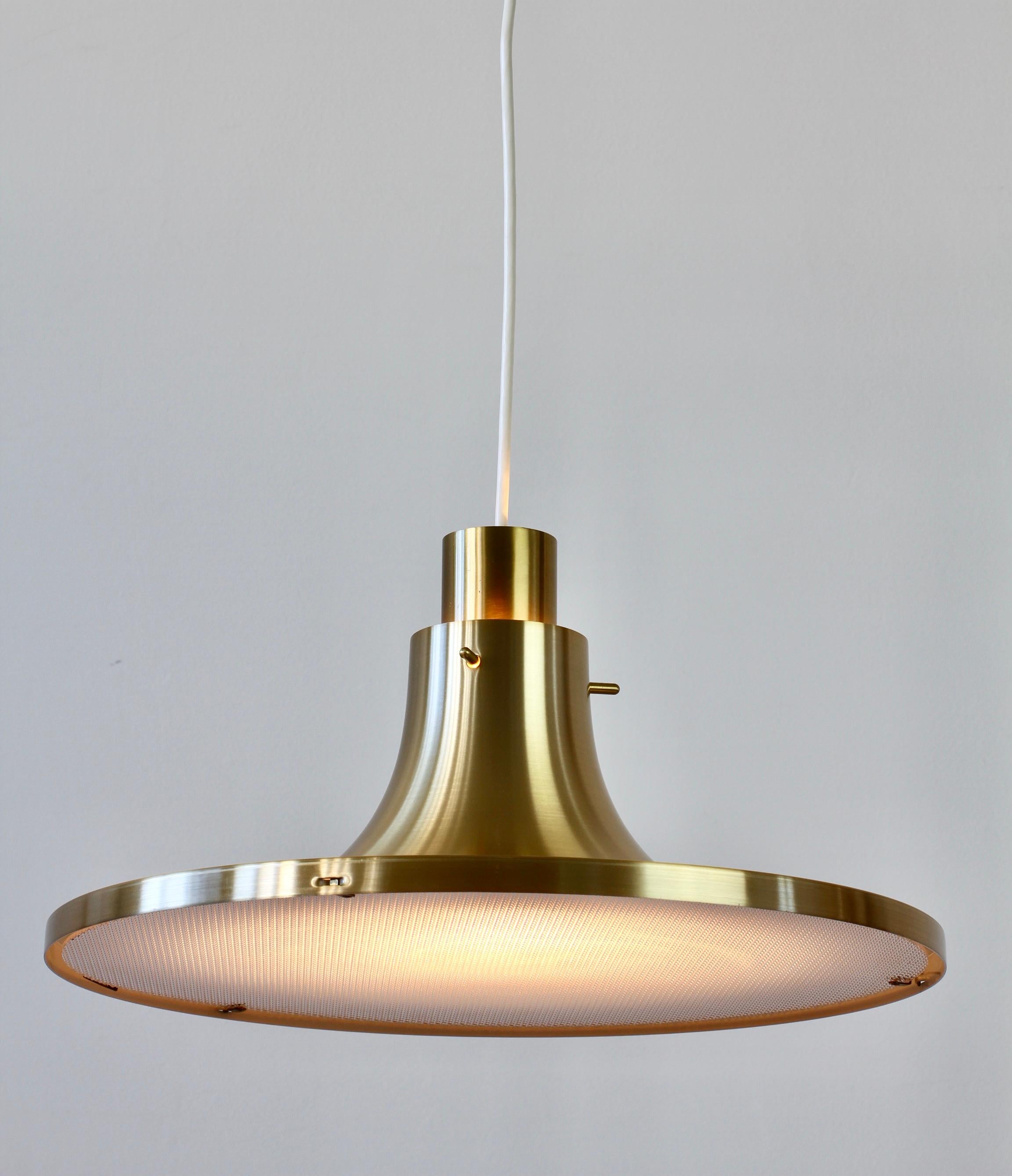 Rare 'New Old Stock' Scandinavian Modern hanging pendant ceiling light / lamp designed by Hans-Agne Jakobssen for AB Markaryd of Sweden with original packaging. Extremely rare to find in this condition and in the full 'brass' 'gold' colored finish.