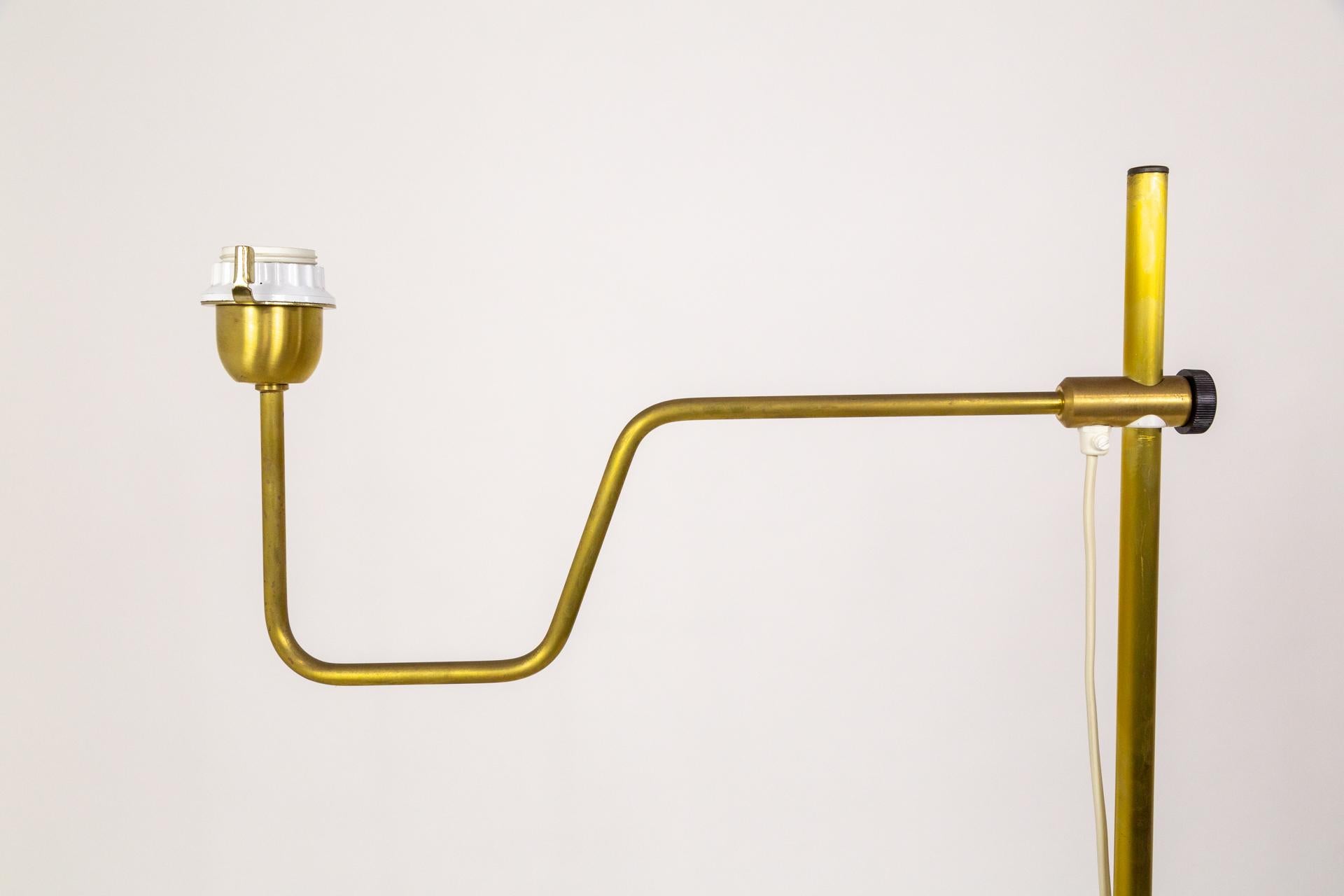 A pair of adjustable brass floor lamps by Markaryd in Sweden; designed by Hans Agne Jakobsson in the mid-20th century. (Maker's sticker on the bottom). 

Height: 67 in (170.18 cm)
Width: 25 in (63.5 cm)
Depth: 13 in (33.02 cm)