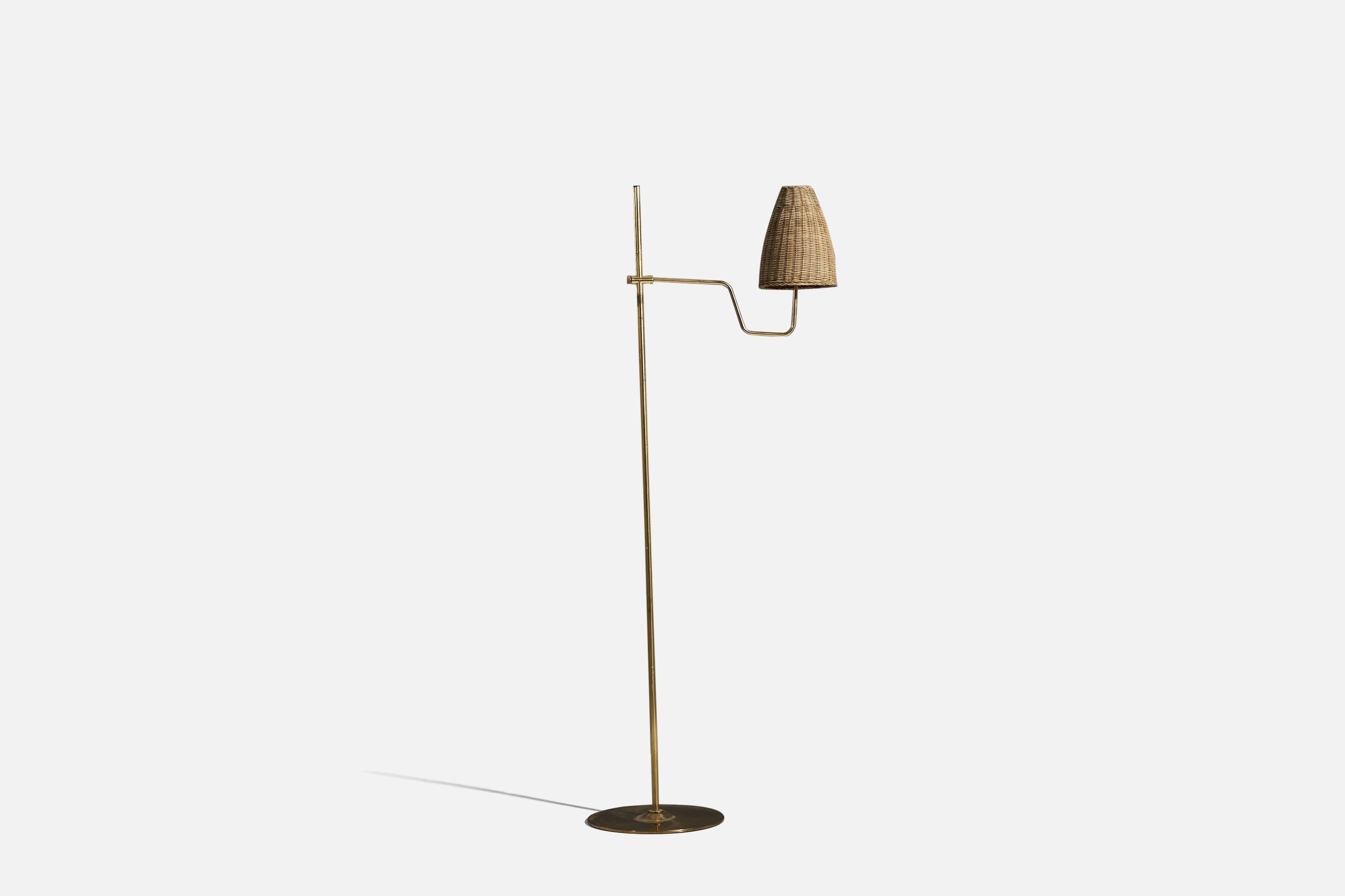 A brass and rattan floor lamp designed by Hans-Agne Jakobsson for his own firm in Markaryd, Sweden. c. 1970s.

Width stated refers to the lamp's maximum extension.
Sold with lampshade.