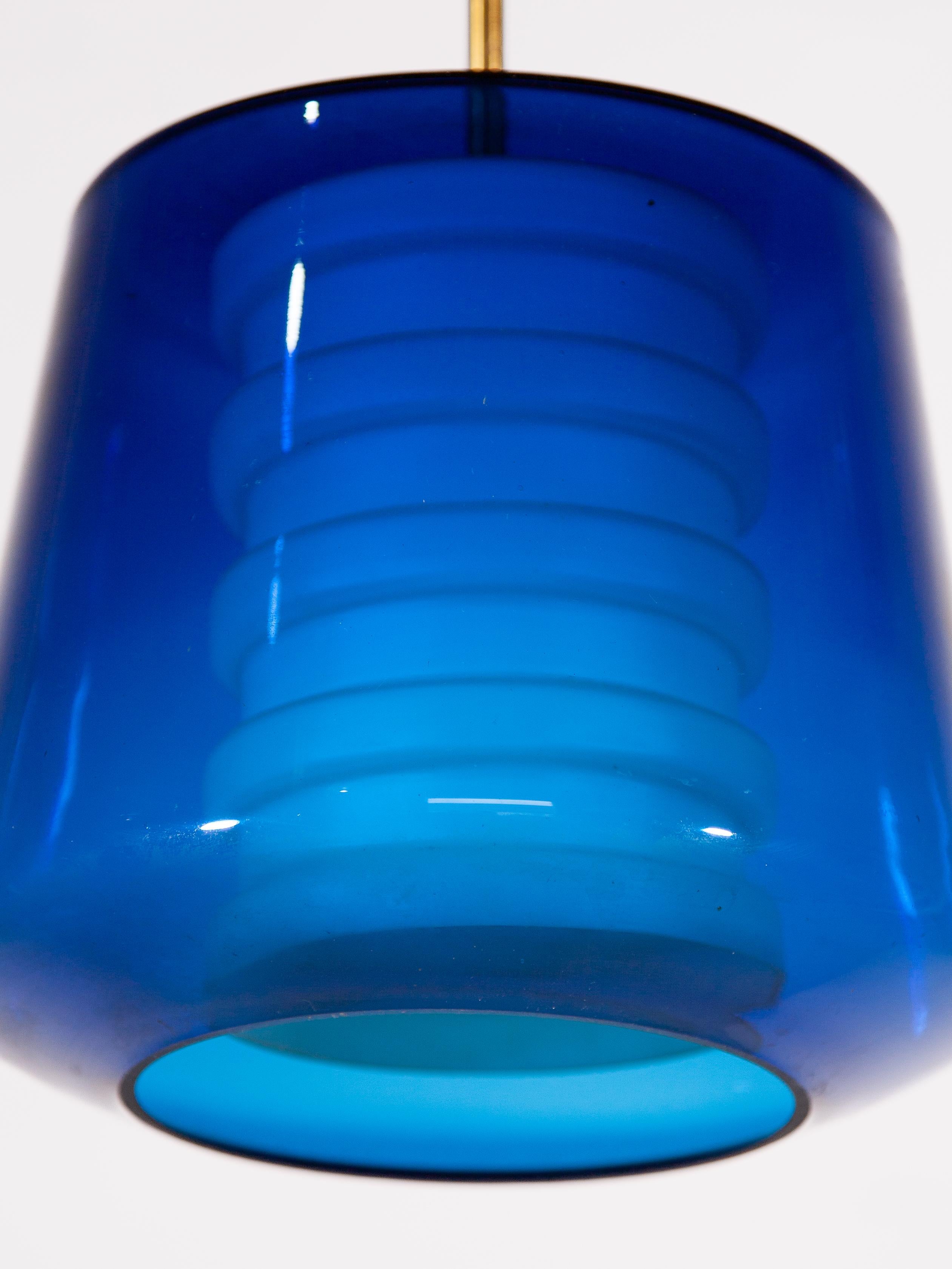 Beautiful rare type pendant in cobalt blue glass mouth blown and opal white glass shade inside with brass accent.
In original good condition ,new rewired for US conditions.
