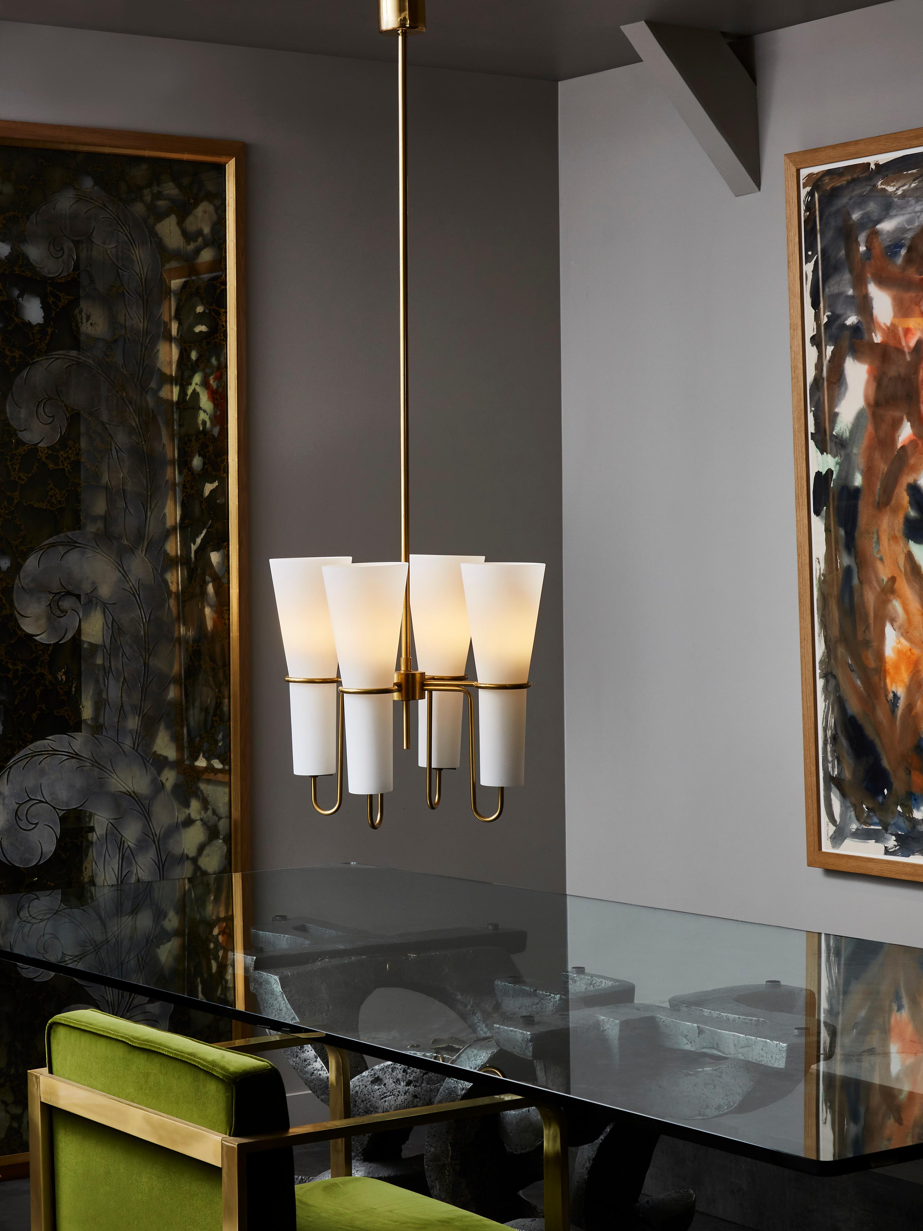 Tall chandelier designed by Hans-Agne Jakobsson made of a brass structure holding four opaline glass sconce.