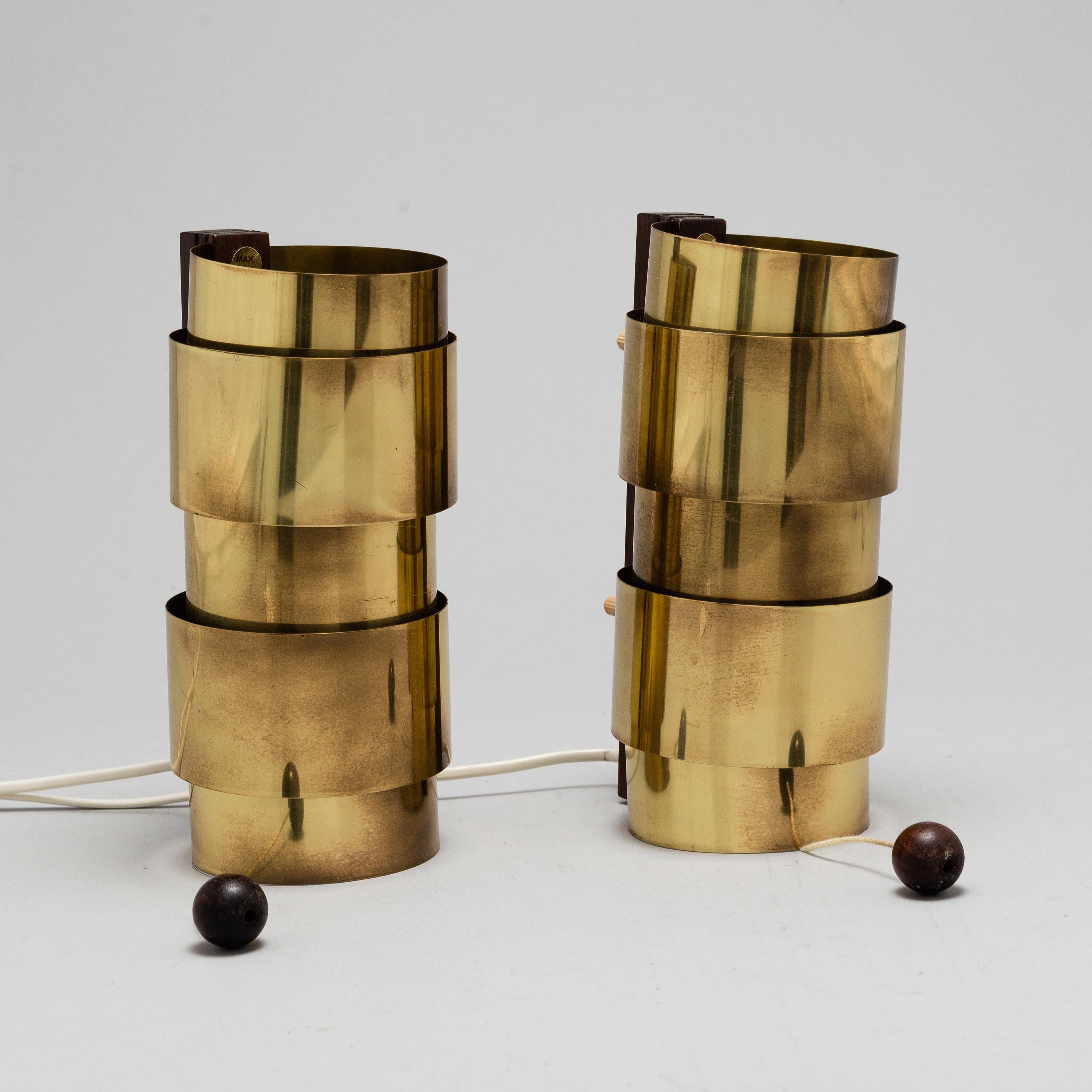 Rare pair of brass and rosewood wall lights by Hans-Agne Jakobsson. Produced by Markaryd, Sweden.
 