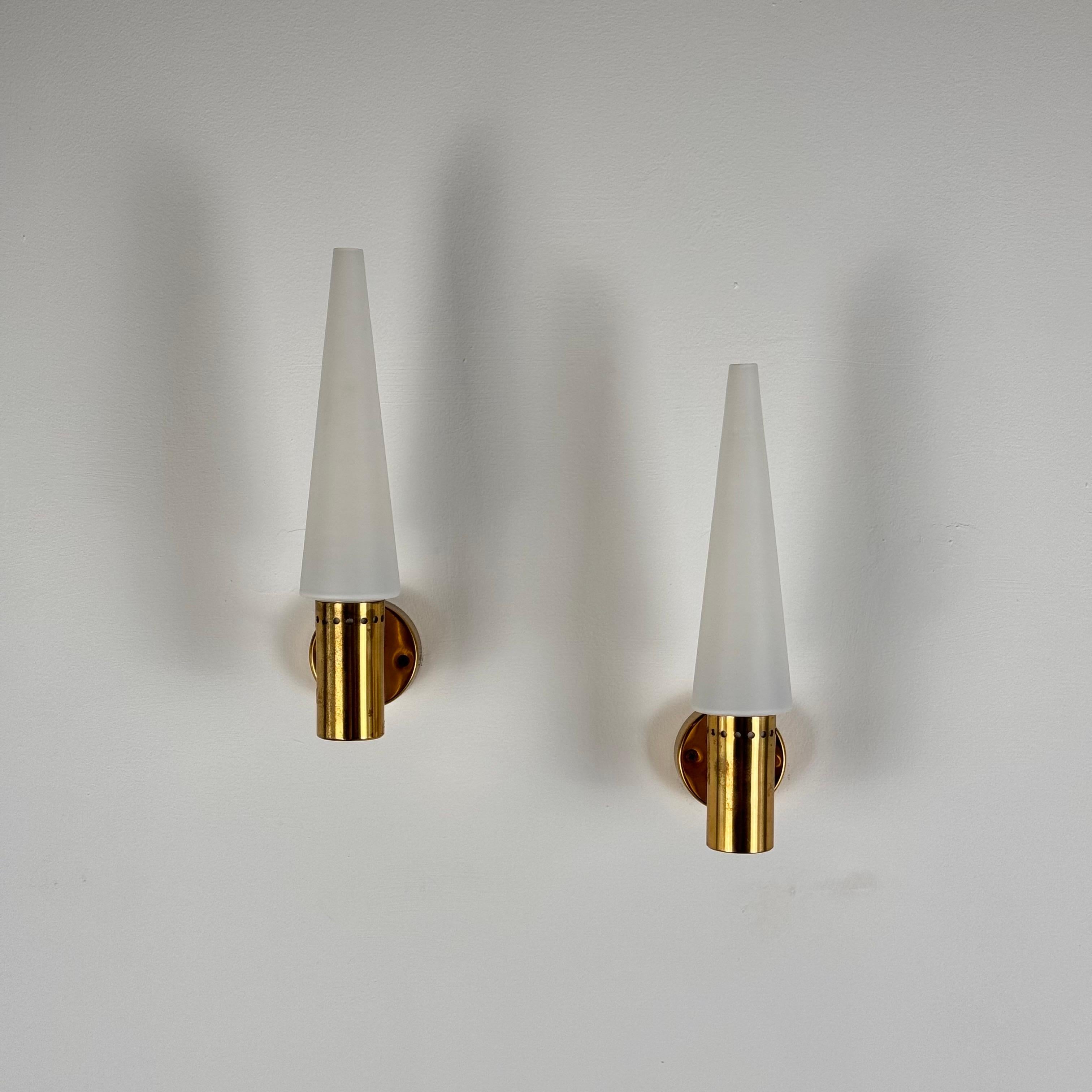 A pair of exquisite wall lights designed by the renowned Swedish designer Hans-Agne Jakobsson for his own firm in Markaryd, Sweden, circa 1960s. These lights showcase the timeless elegance and refined craftsmanship typical of Scandinavian design.