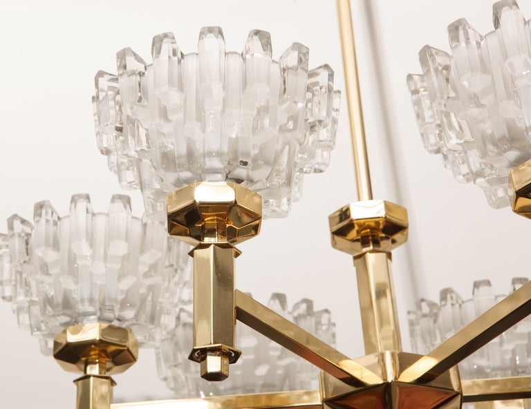 Scandinavian modern brass frame chandeliers with six frosted and polished crystal cups designed by Hans-Agne Jakobsson. Rewired for use in the USA using Edison type bulbs.
