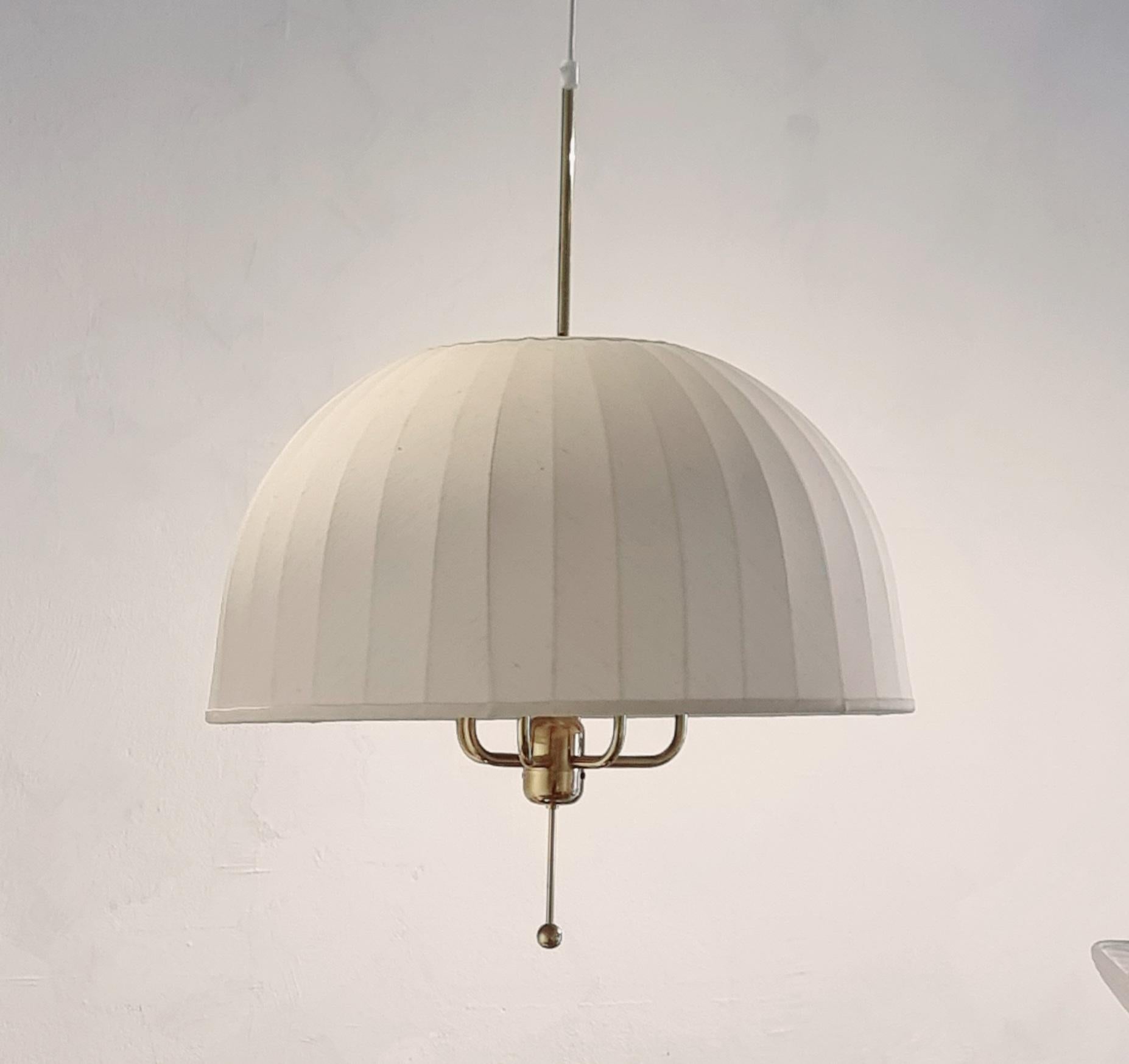 Large, six-armed Scandinavian Modern pendant lamp, Model “T549/6” Carolin, designed by Hans Agne Jakobsson and produced by AB Markaryd in the 1960s.

Frame in brass and the shade in the original off-white fabric. 
Original label intact on shade. In