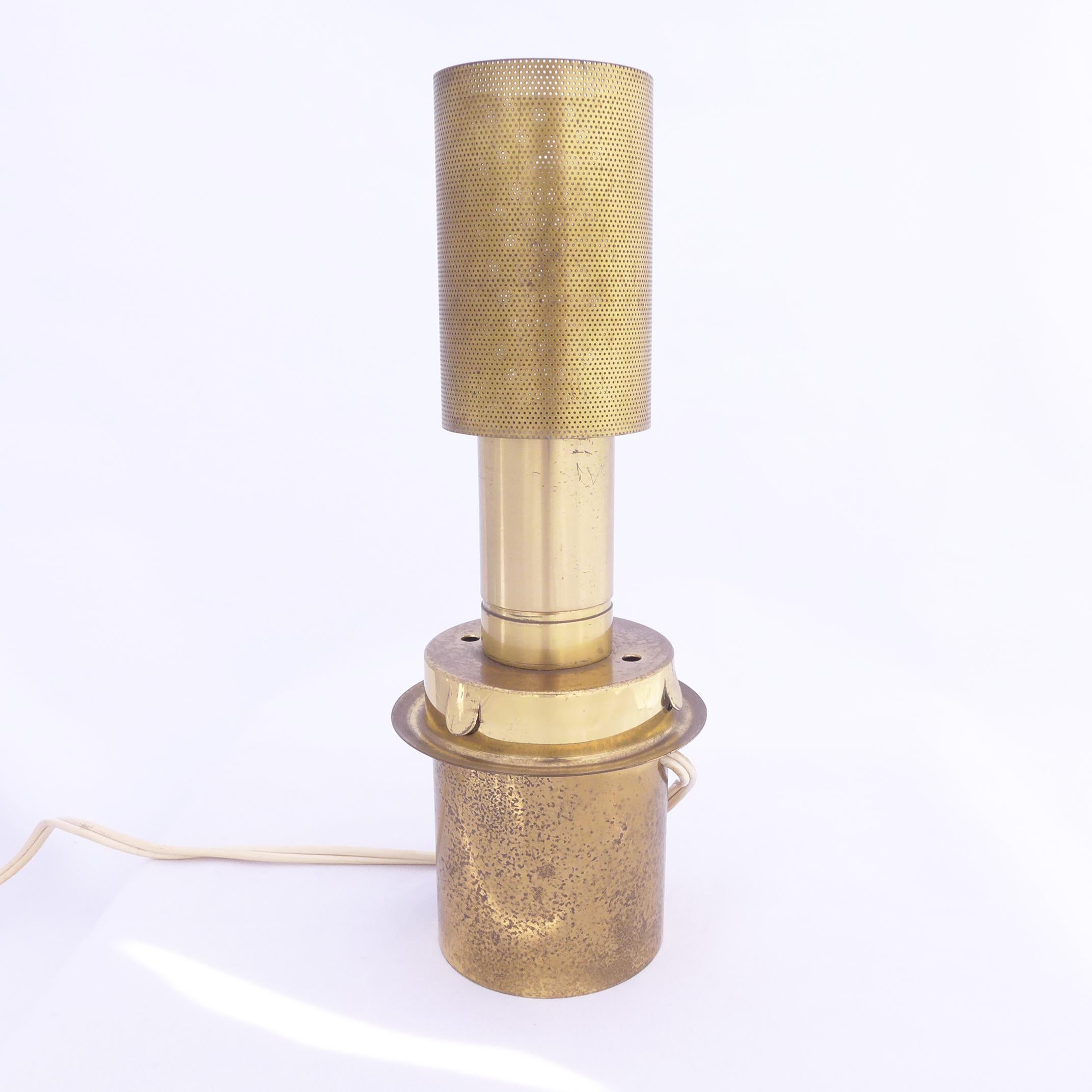 Elegant brass table lamp with rose-tinted glass chimney by the prolific Swedish designer Hans-Agne Jakobsson. The original brass patina is visible revealing the age and character of the material. It is also possible to polish the brass to give it a