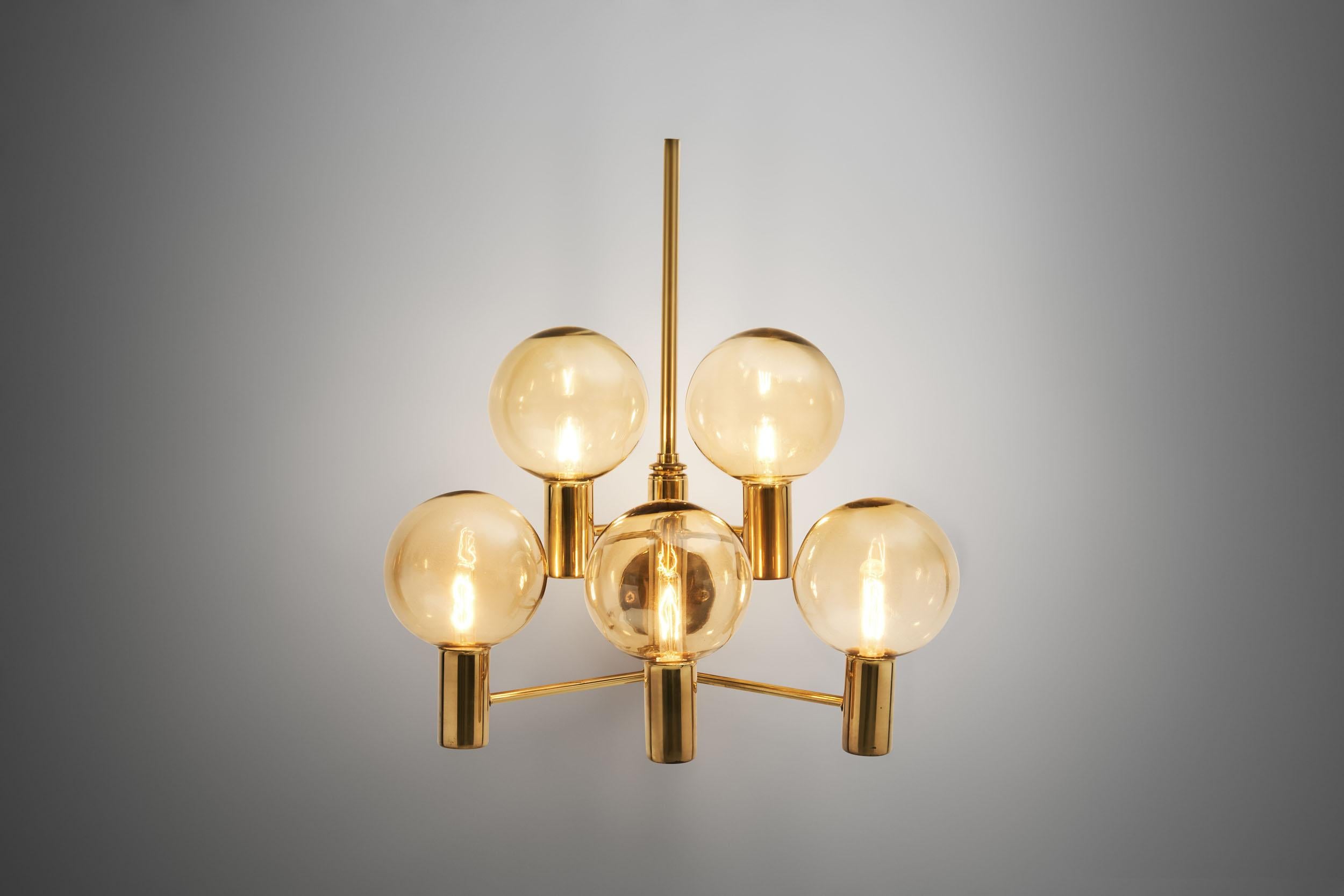 This wall lamp is perhaps the most stunning model of Jakobsson’s. With a brass frame holding five smoked, translucent glass shades, this lamp is the upgraded, larger version of the model V 149/3. The design clearly shows the Swedish designer’s