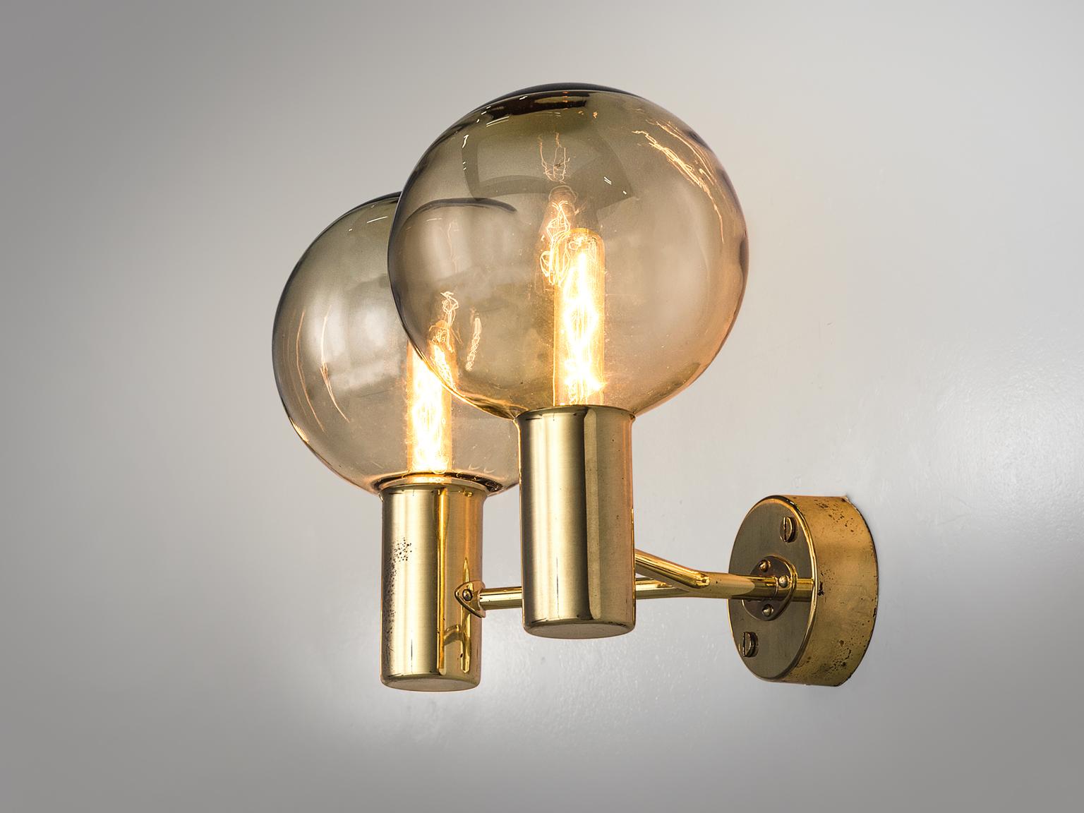 Hans-Agne Jakobsson for AB in Markaryd, wall lights in brass and smoked glass, Denmark, 1960s. 

Set of two solid brass sconces with glass shades with a smoked light brown finish. The lights each have two arms ending in a glass smoked brown