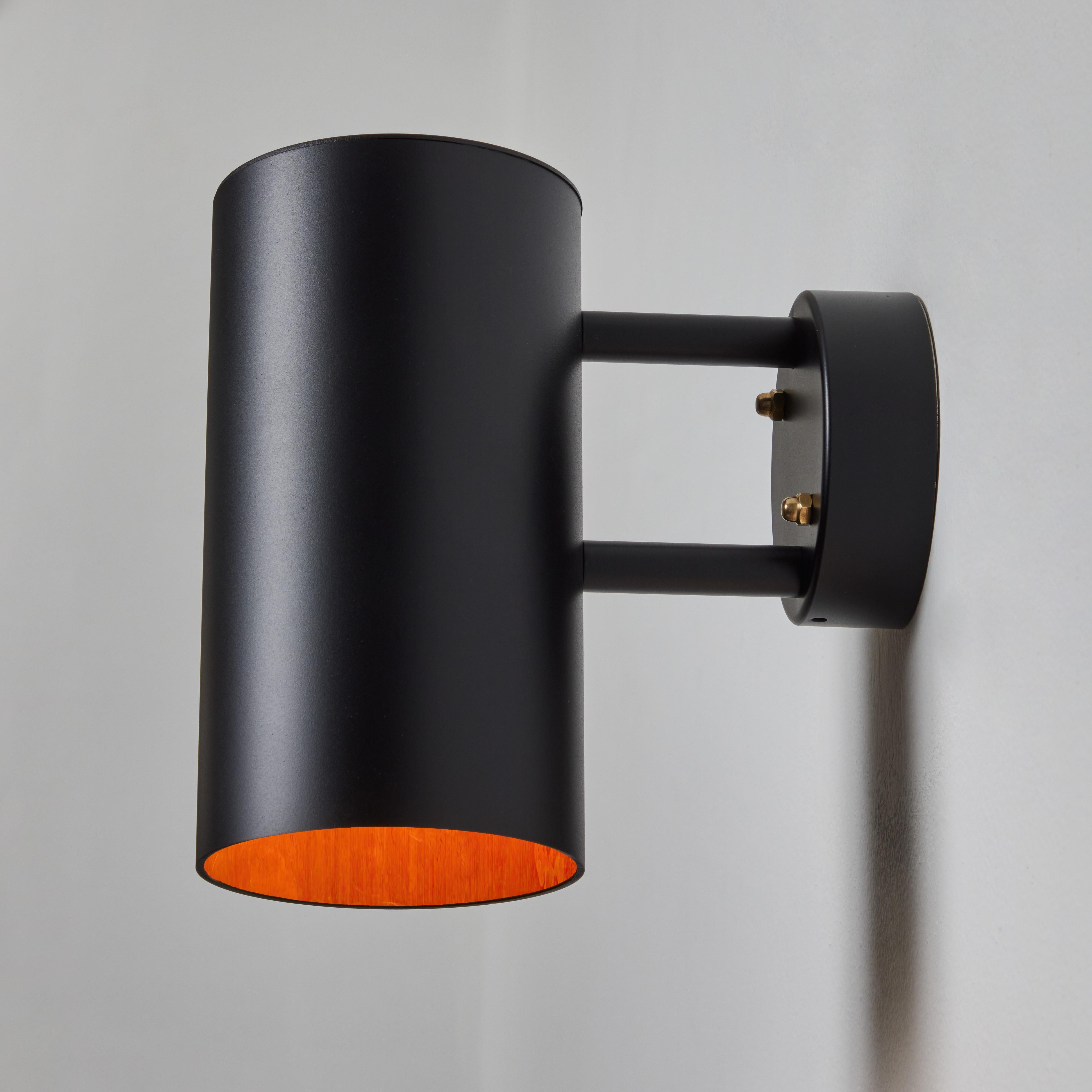 Hans-Agne Jakobsson C627/110 'Rulle' outdoor sconce in black. An exclusive made for U.S. and UL listed authorized re-edition of the classic Swedish design executed in black painted metal with a raw metal interior that will continue to develop a