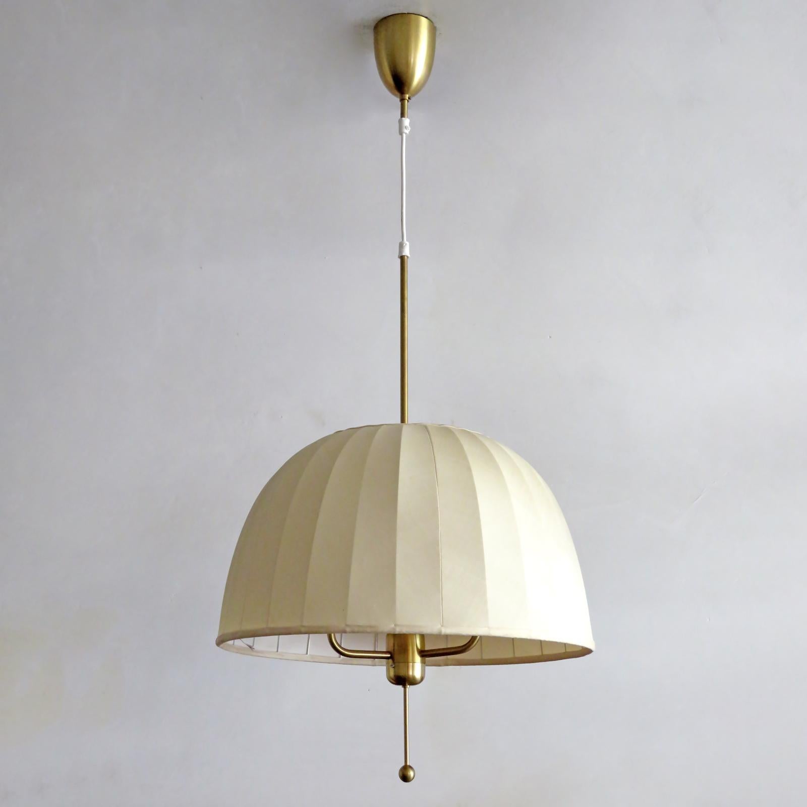 Wonderful pendant lamp 'Carolin' model T549/3 designed by Hans-Agne Jakobsson for Markaryd, Sweden, 1960, with brass frame covered by a fabric shade, with original brass canopy. The overall drop as well as the vertical position of the shade is