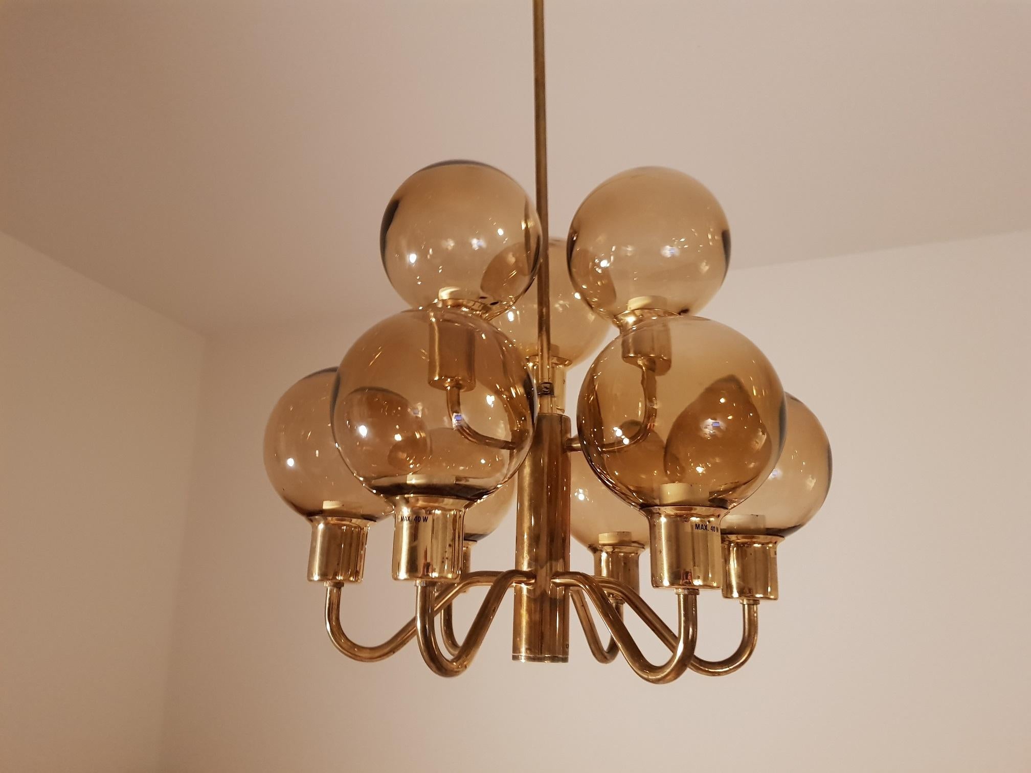 1 beautiful vintage ceiling lamp in brass and smoked glass. Rare model that is not often for sale. Produced in the 1960s by Hans-Agne Jakobsson AB in Markaryd Sweden. A total of 9 light sources. Each glass case is 12 cm in diameter. Scandinavian