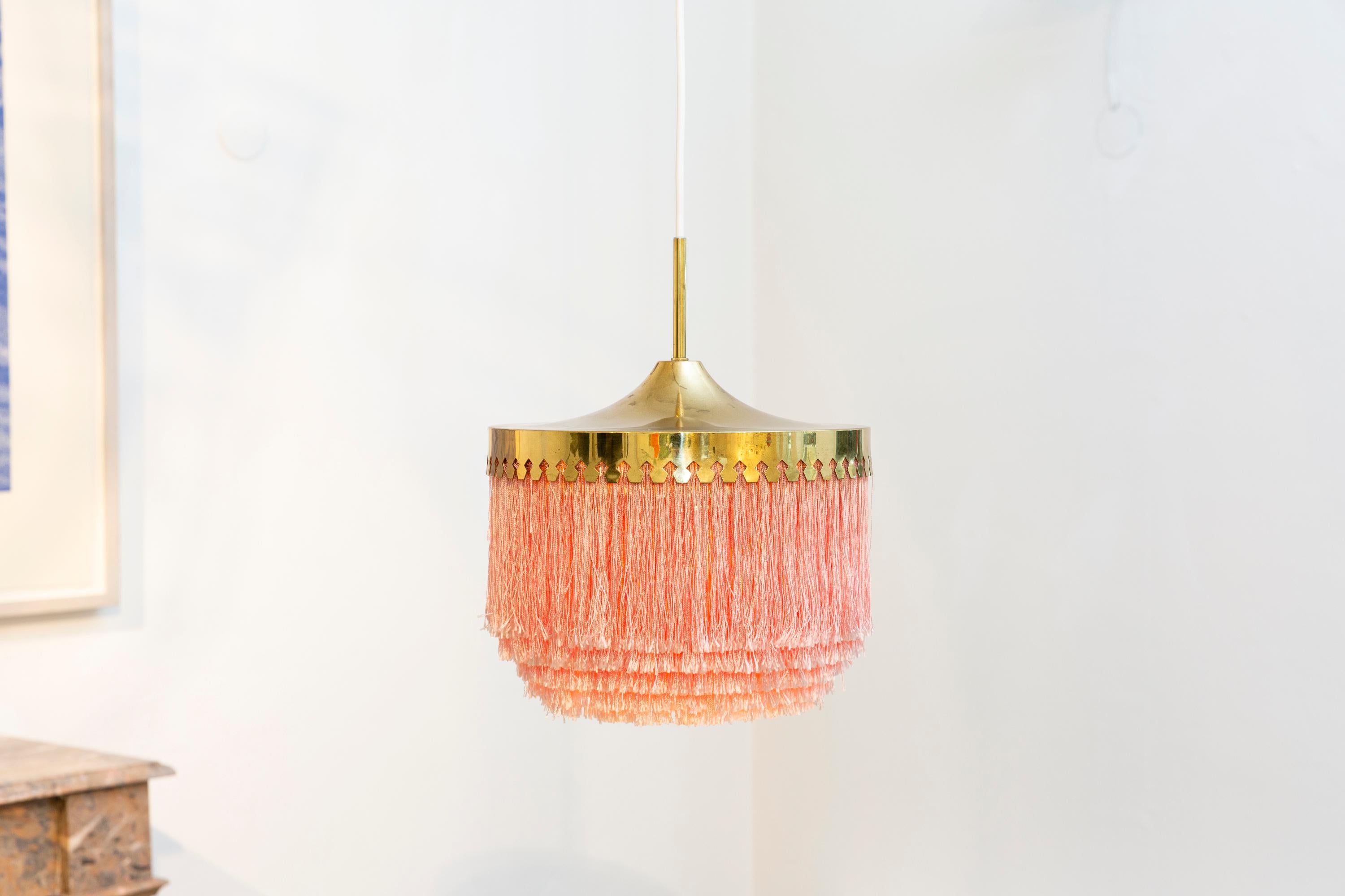 Beautiful Hans-Agne Jakobsson pink fringe ceiling lamp in brass. Produced by Hans-Agne Jakobsson AB in Markaryd, Sweden.