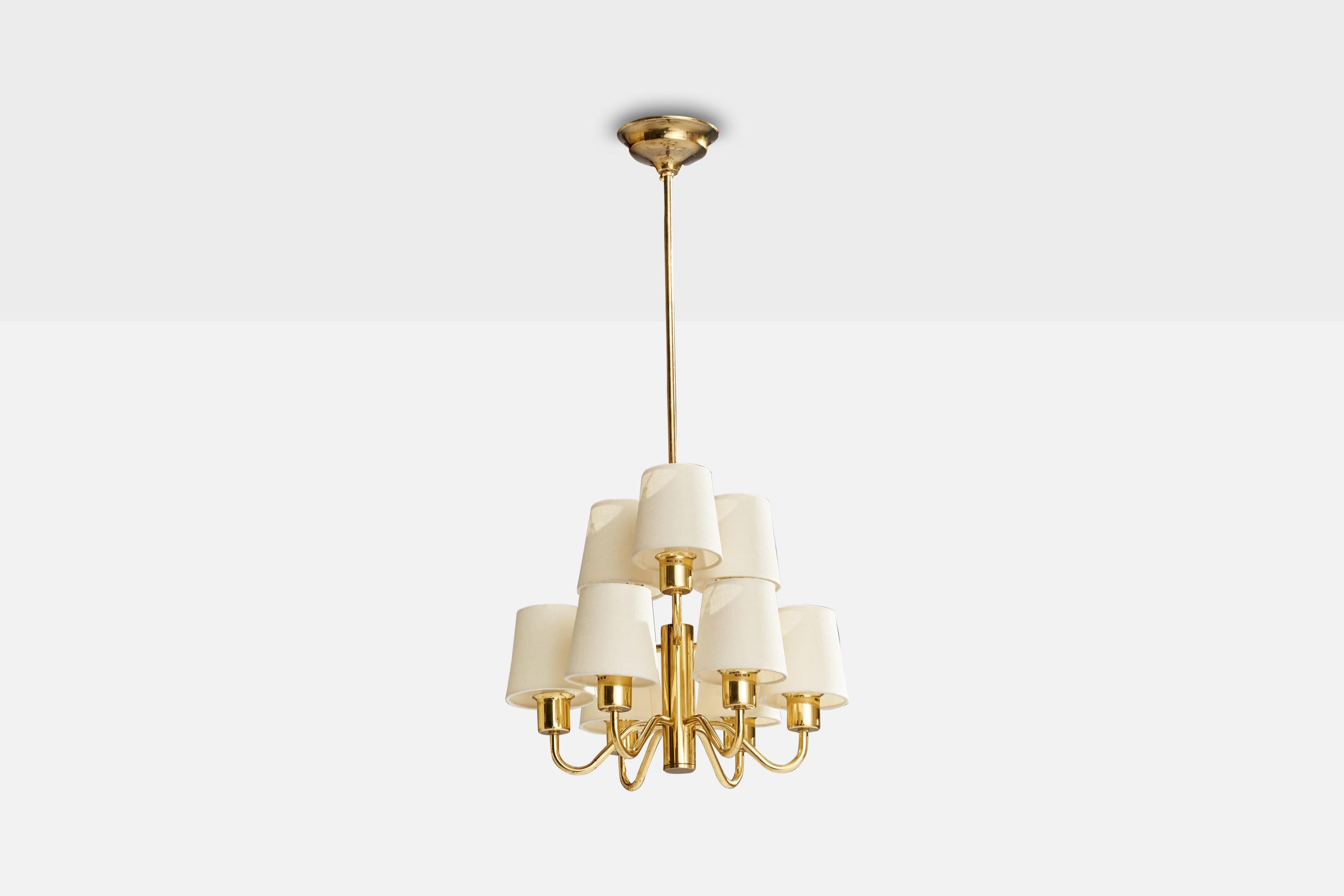 A brass and off-white fabric chandelier designed and produced by Hans-Agne Jakobsson, Sweden, c. 1960s.

Dimensions of canopy (inches): 2” H x 4.75” Diameter
Socket takes standard E-14 bulbs. 9 sockets.There is no maximum wattage stated on the