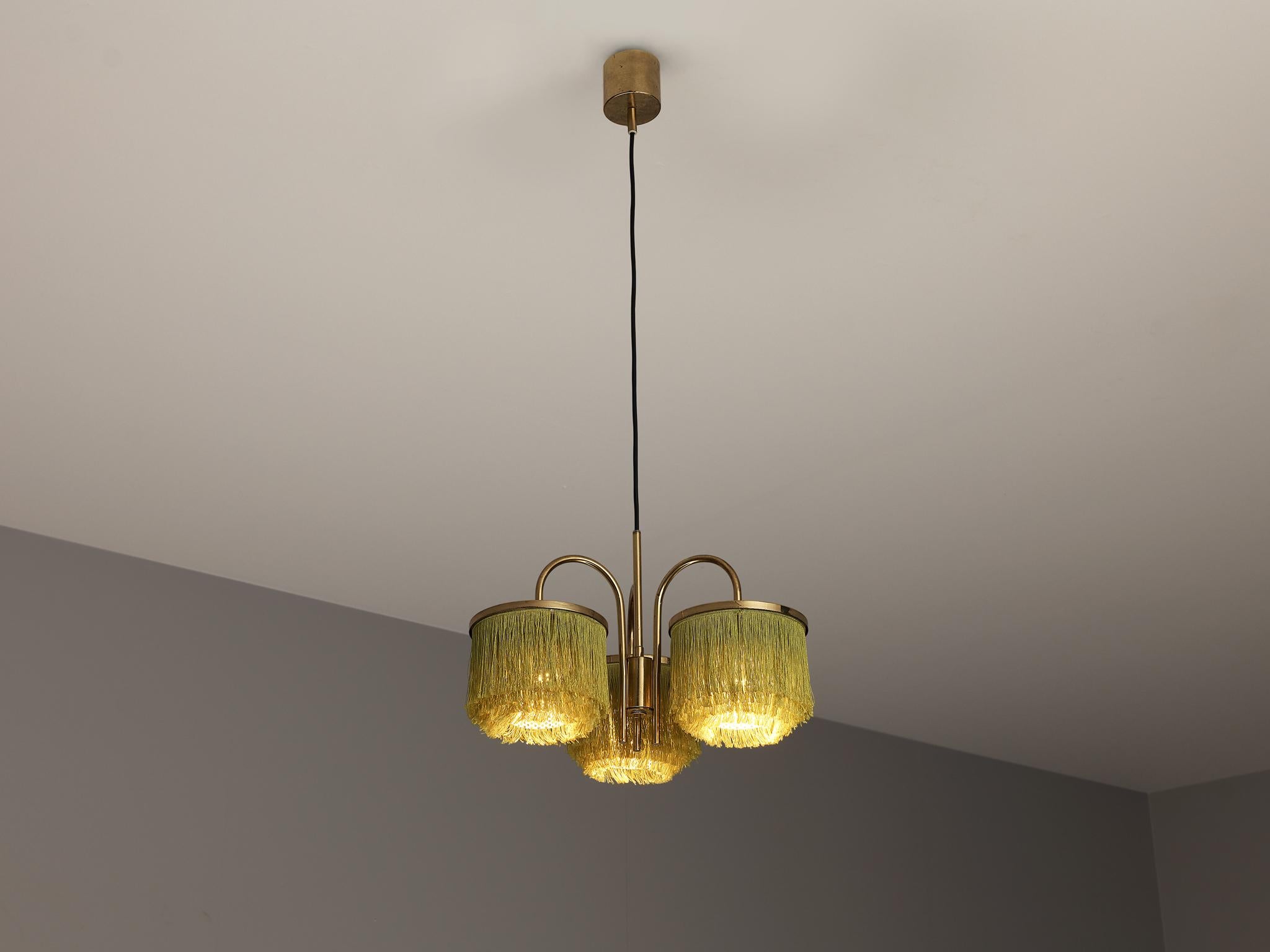 Hans-Agne Jakobsson for Hans-Agne Jakobsson AB in Markaryd, brass, silk string, Europe, 1960s.

This extravagant 'fringe' chandelier is designed by Swedish designer Hans-Agne Jakobsson. Its frame holds three rounded arms with each a round pendant