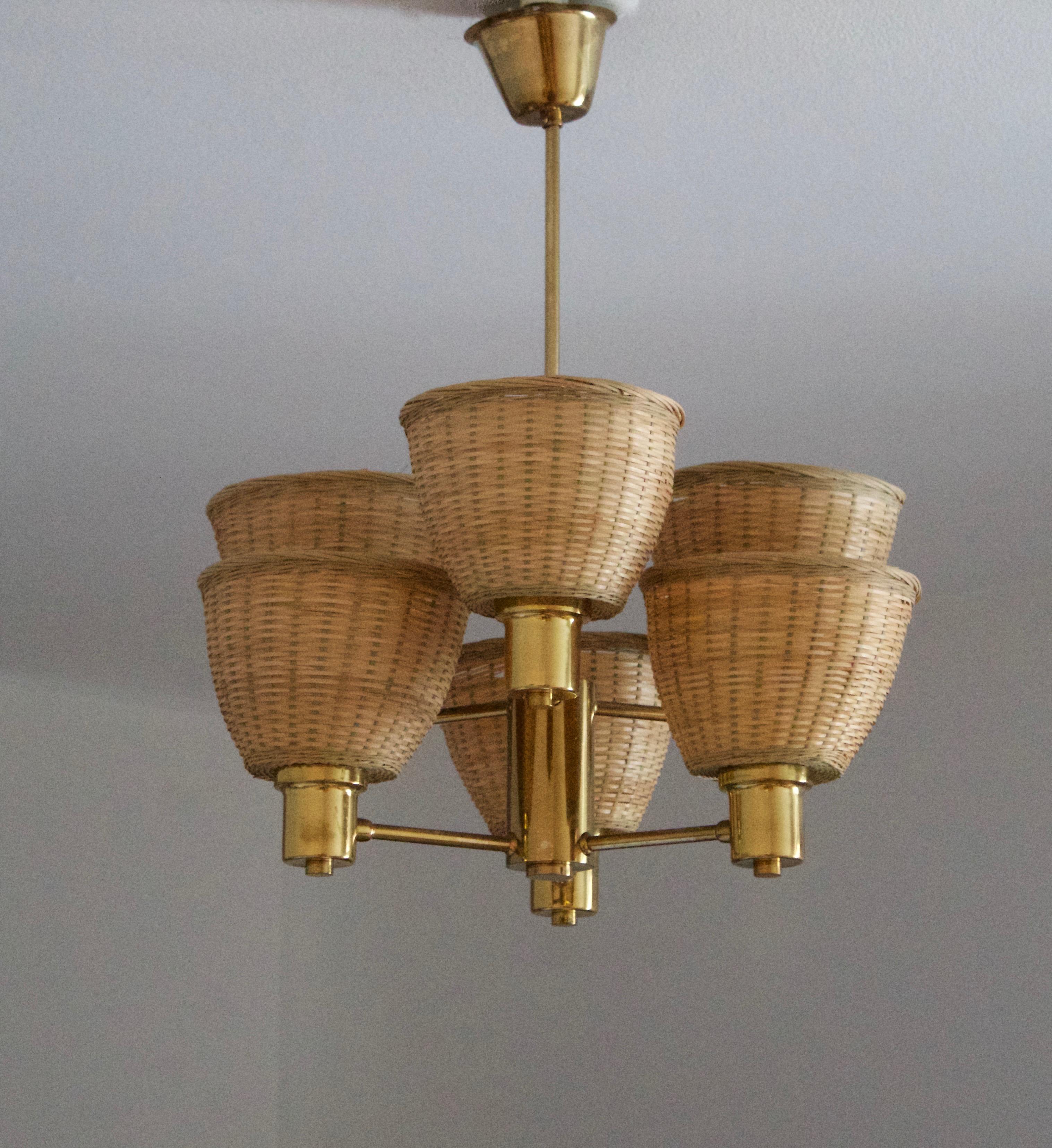 A chandelier, design attributed to Hans-Agne Jakobsson. Presumably by his own firm in Markaryd, Sweden. c. 1960s. Unmarked.

Assorted vintage rattan lampshades.