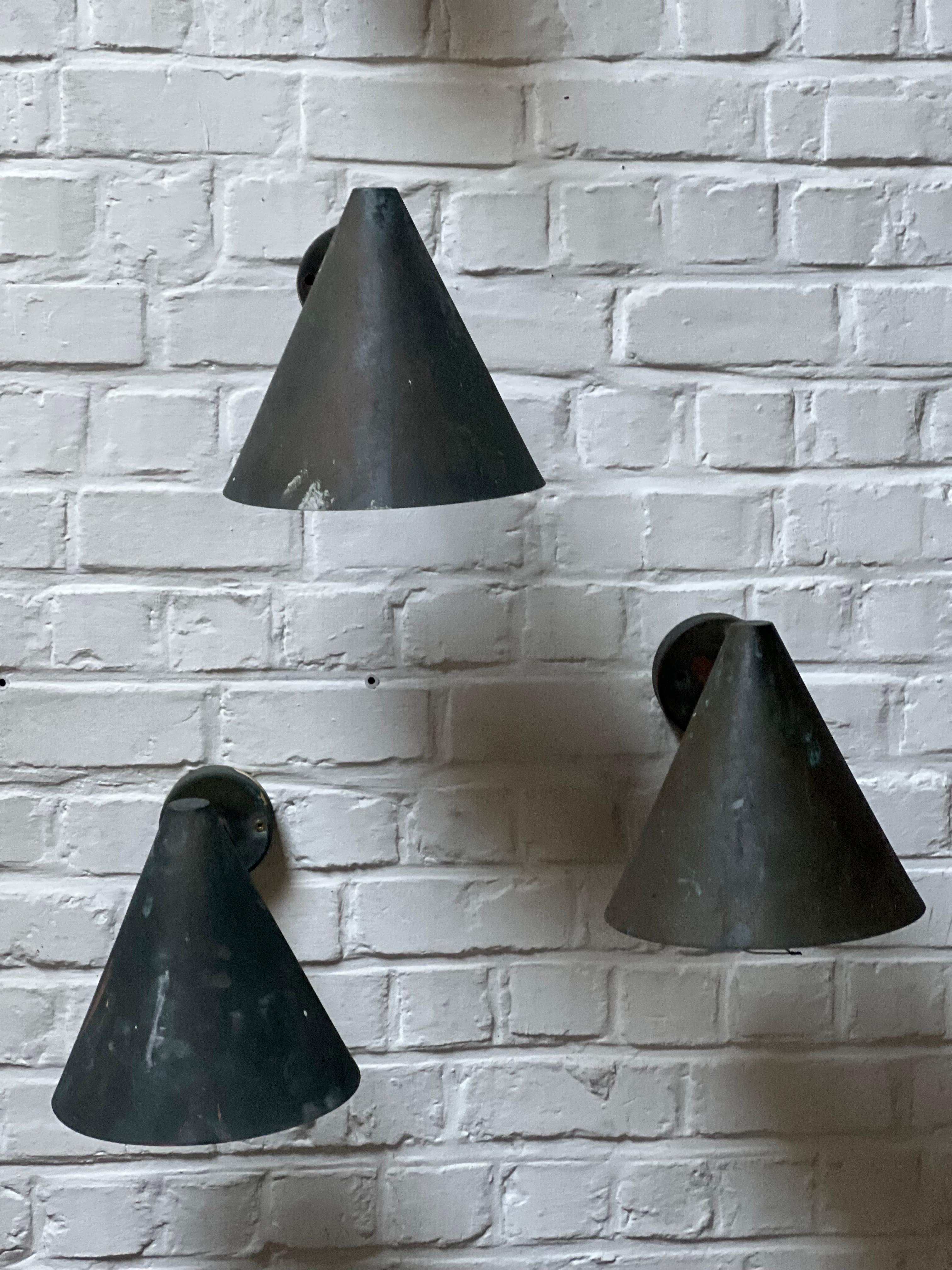 This is the famous conical copper wall lamp from Hans Agne Jakobsson. Made in Sweden in the 1960's. They can be used outside or inside. Very warm shades of green patina on the massive copper lamps. We have 3 lamps available and more on