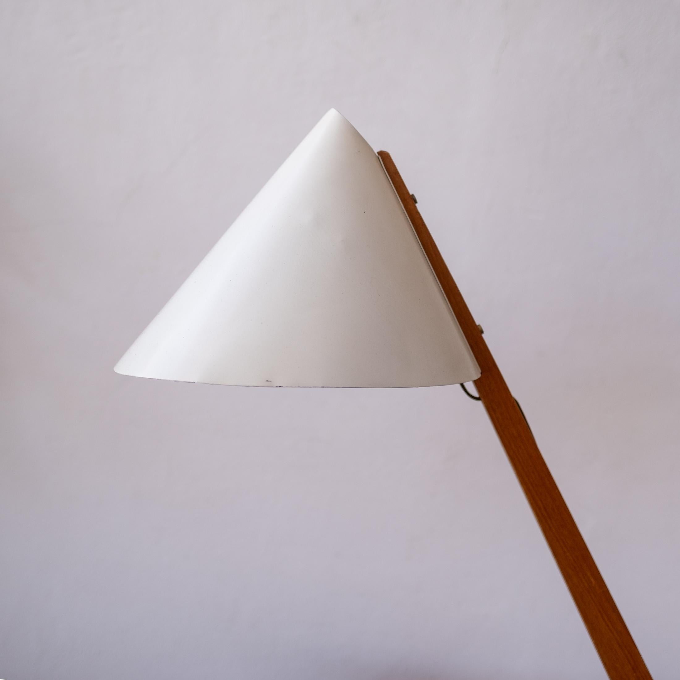 Model B 54 lamp by Hans-Agne Jakobsson for Markaryd. This architect's desk lamp has a metal shade, teak arm, brass hardware and a heavy swivel base. It's a beautiful and functional piece of design. Original paint and labels, Sweden, 1950s.