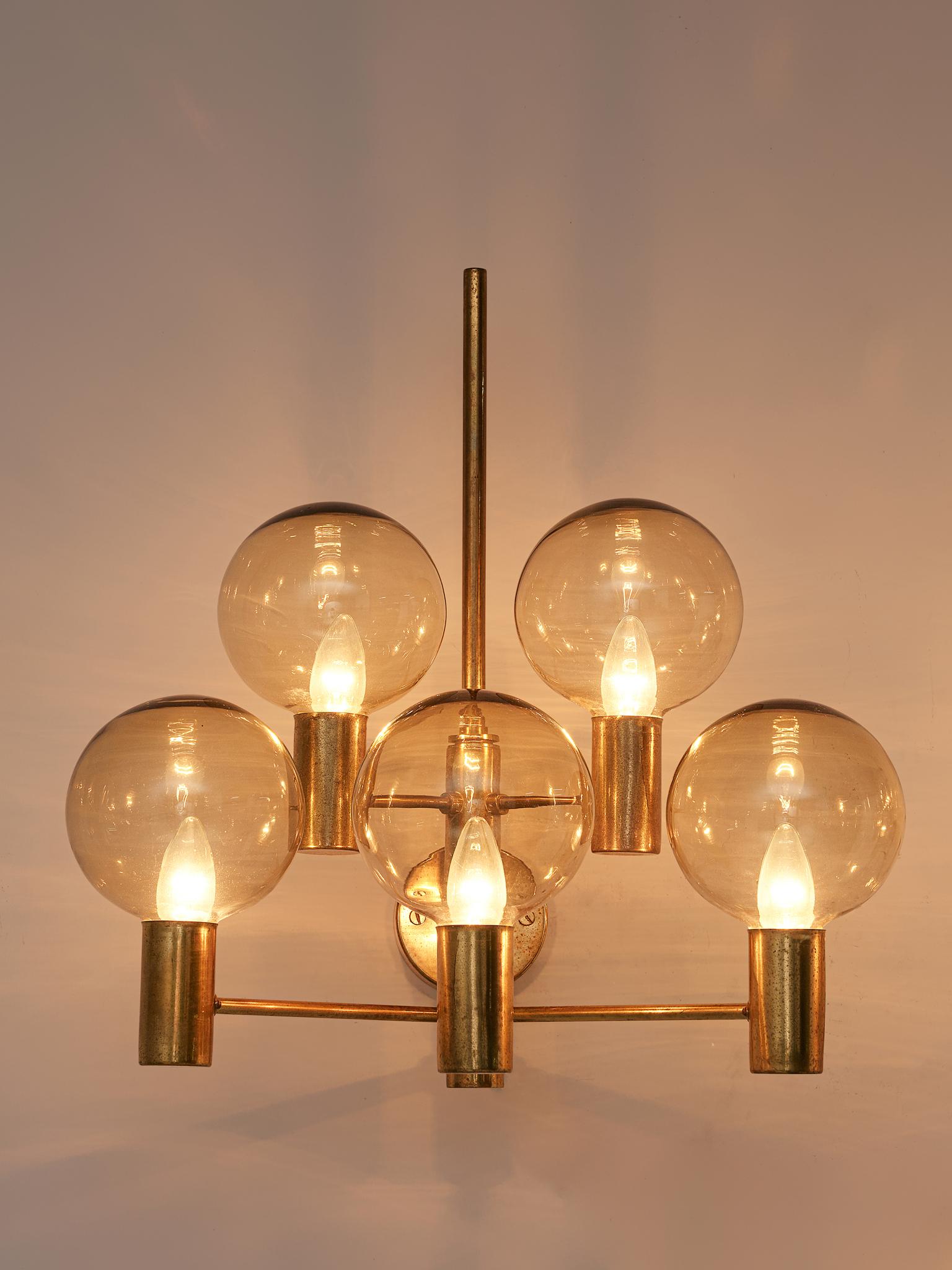 Hans Agne Jakobsson, wall light, brass, glass, Sweden, 1960s.

A large wall light in patinated brass with clear glass shades by Hans Agne Jakobsson. Divided over five arms this light creates a stunning light partition. The lights are large and