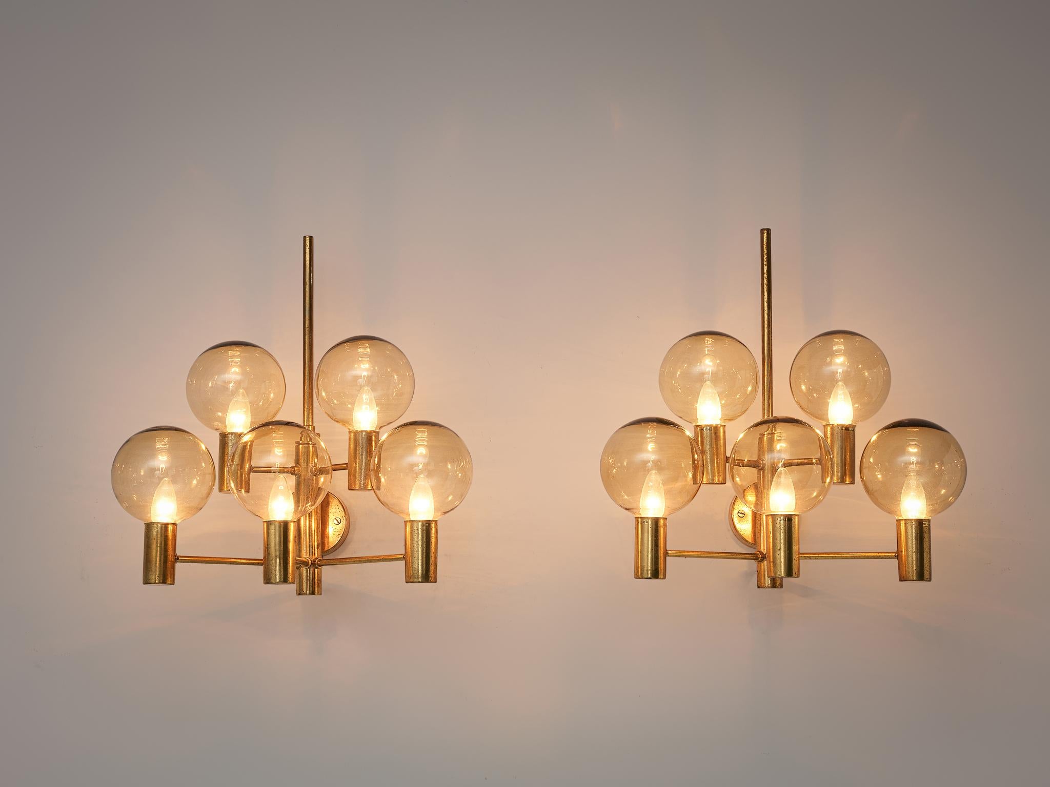 Hans Agne Jakobsson, wall lights, brass, glass, Sweden, 1960s.

Two large wall lights in patinated brass with clear glass shades by Hans Agne Jakobsson. Divided over five arms this light creates a stunning light partition. The lights are large and