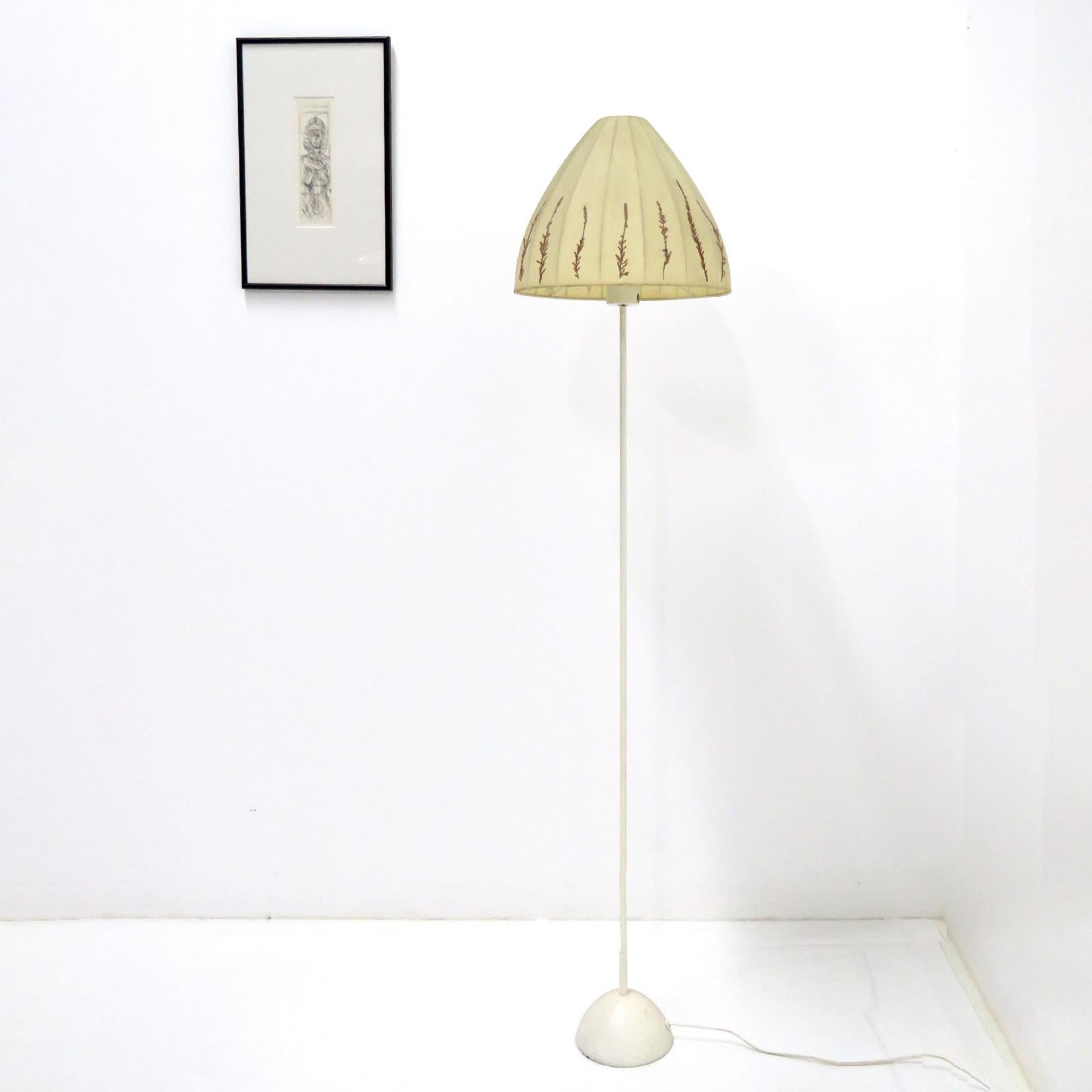 Wonderful floor lamp by Hans-Agne Jakobsson for Markaryd, Sweden, 1960, fabric shade with floral applications on an enameled metal base, wired for US standards, one E27 socket, max. wattage 75w, bulb provided as a onetime courtesy, marked with