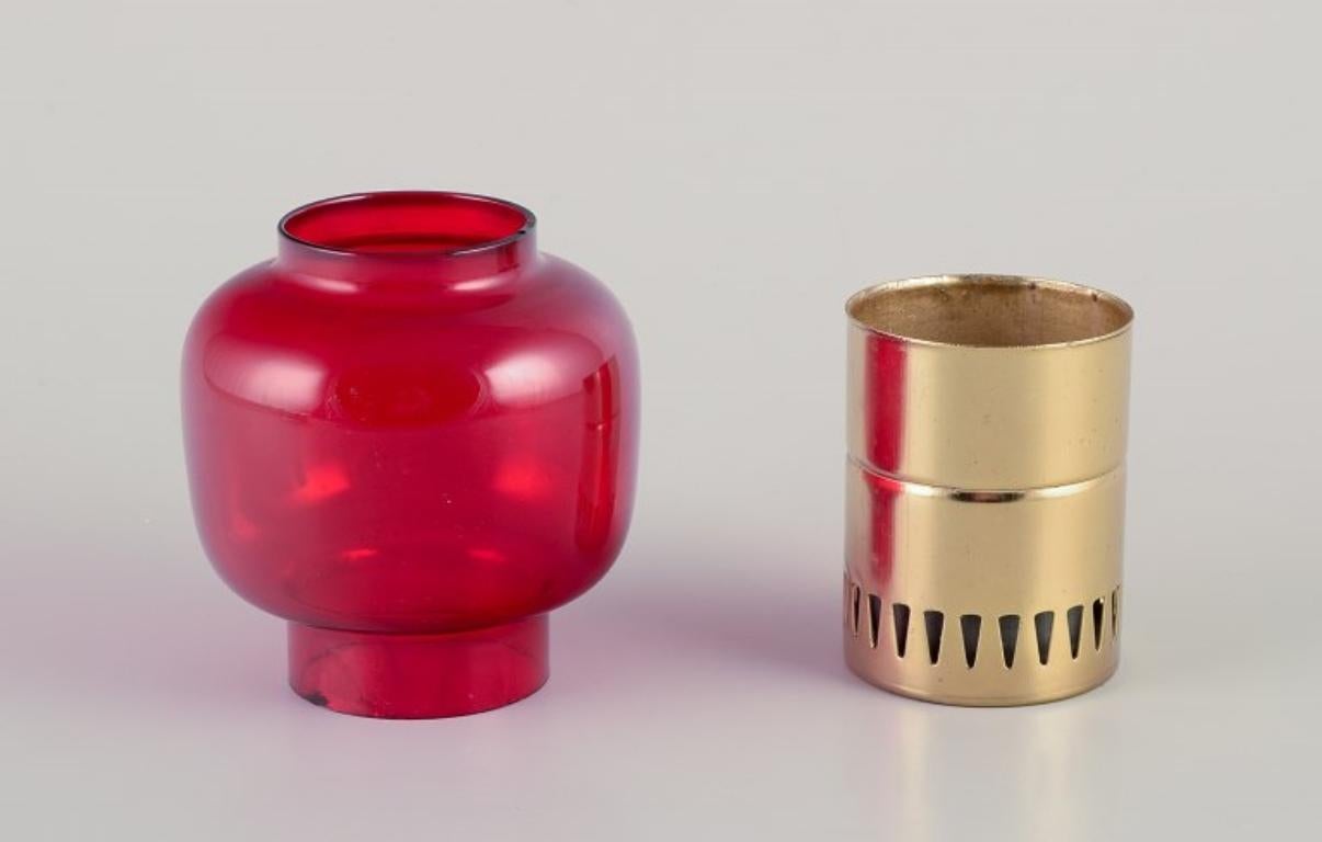 Scandinavian Modern Hans-Agne Jakobsson for A/B Markaryd. Candle holder in brass and red glass.