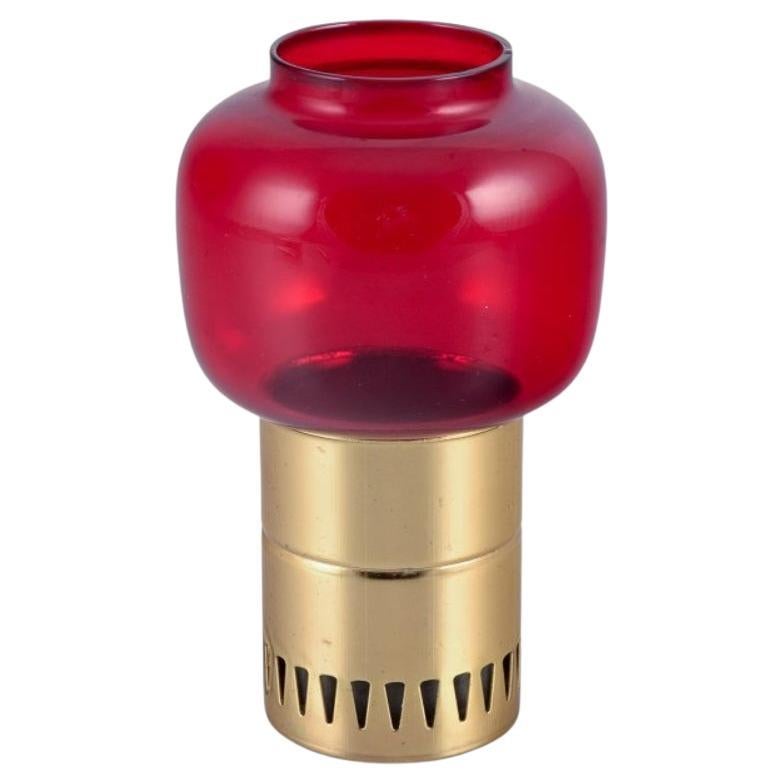 Hans-Agne Jakobsson for A/B Markaryd. Candle holder in brass and red glass.