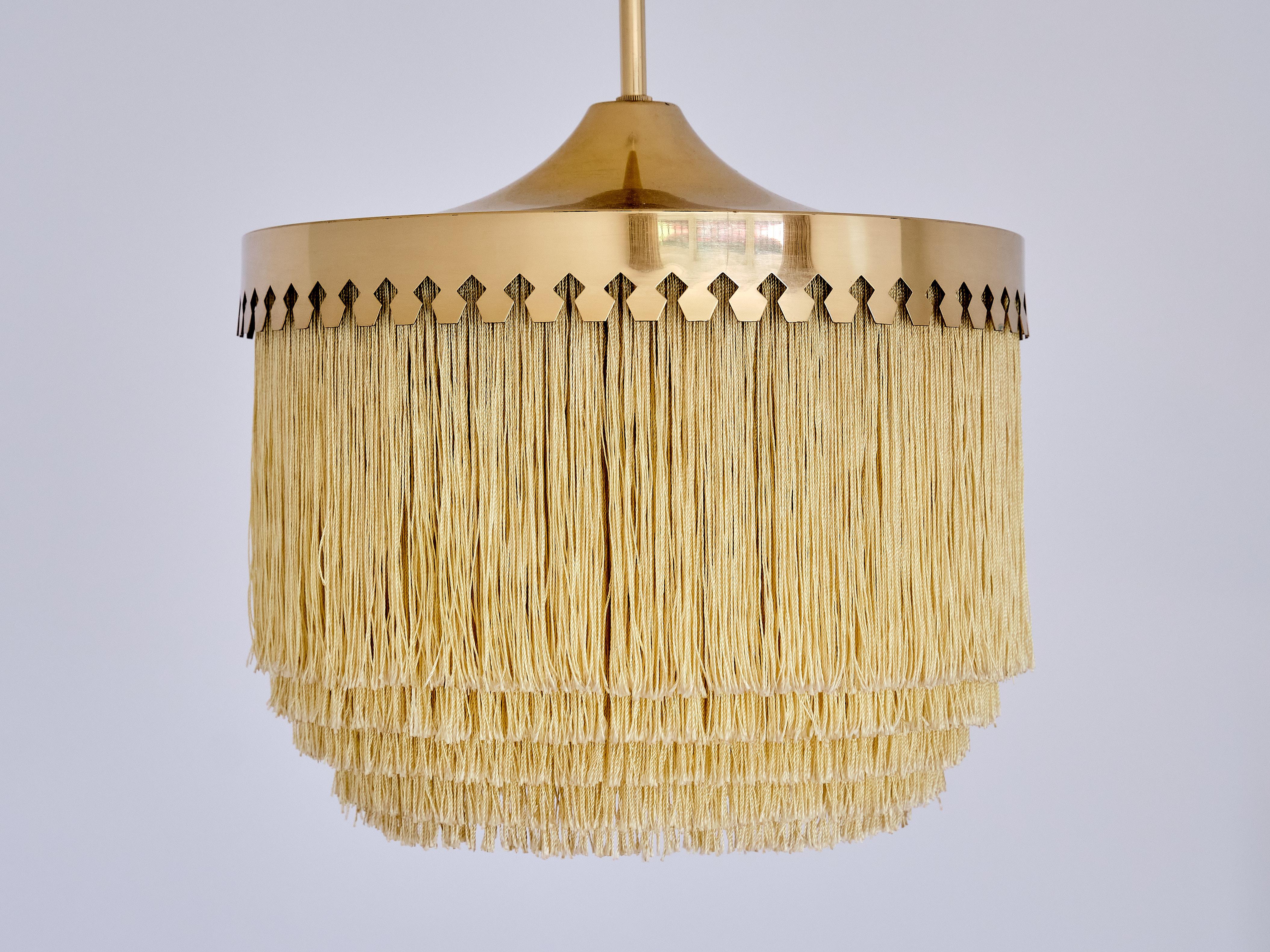 This striking pendant light was designed by Hans-Agne Jakobsson and produced by his company in Markaryd, Sweden in the 1960s. This model was numbered T601 and is part of his iconic fringe series.

The design is marked by the brass fixture with its