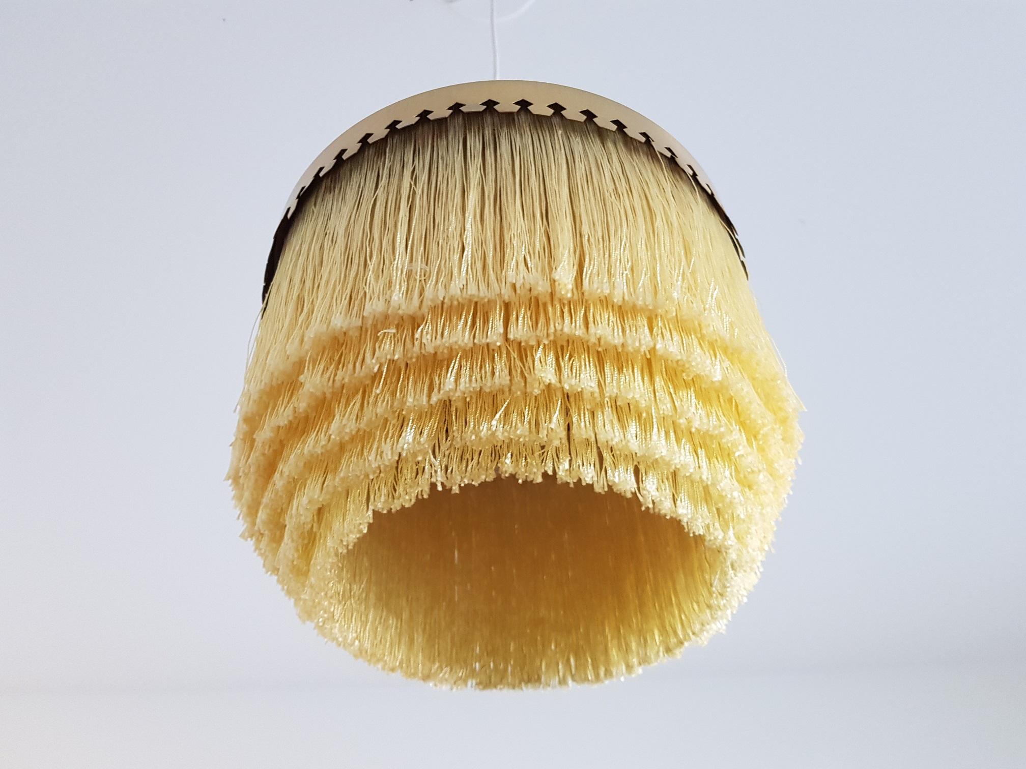 Vintage yellow fringe lamp in brass. Produced in the 1960s by Hans-Agne Jakobsson AB in Markaryd Sweden. This famous ceiling lamp has had an unbelievable revival the last few years and is now found in the most iconic hotel lounges, private homes,