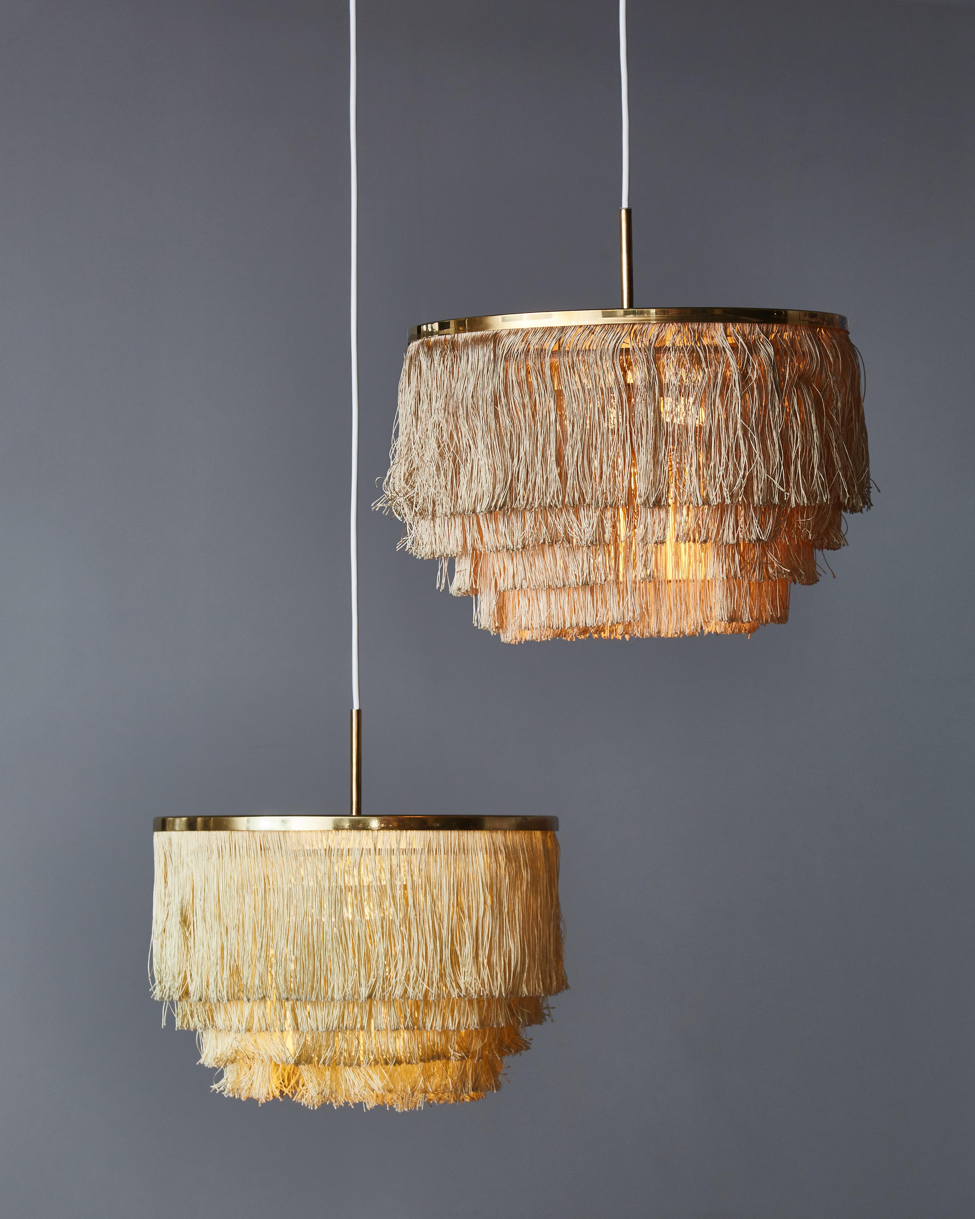 Pair of pendants designed by Hans-Agne Jakobsson in the 1960s made of a round brass structure and multiple layers of fringes all around.
Can be sold separately, price displayed for one piece.
 