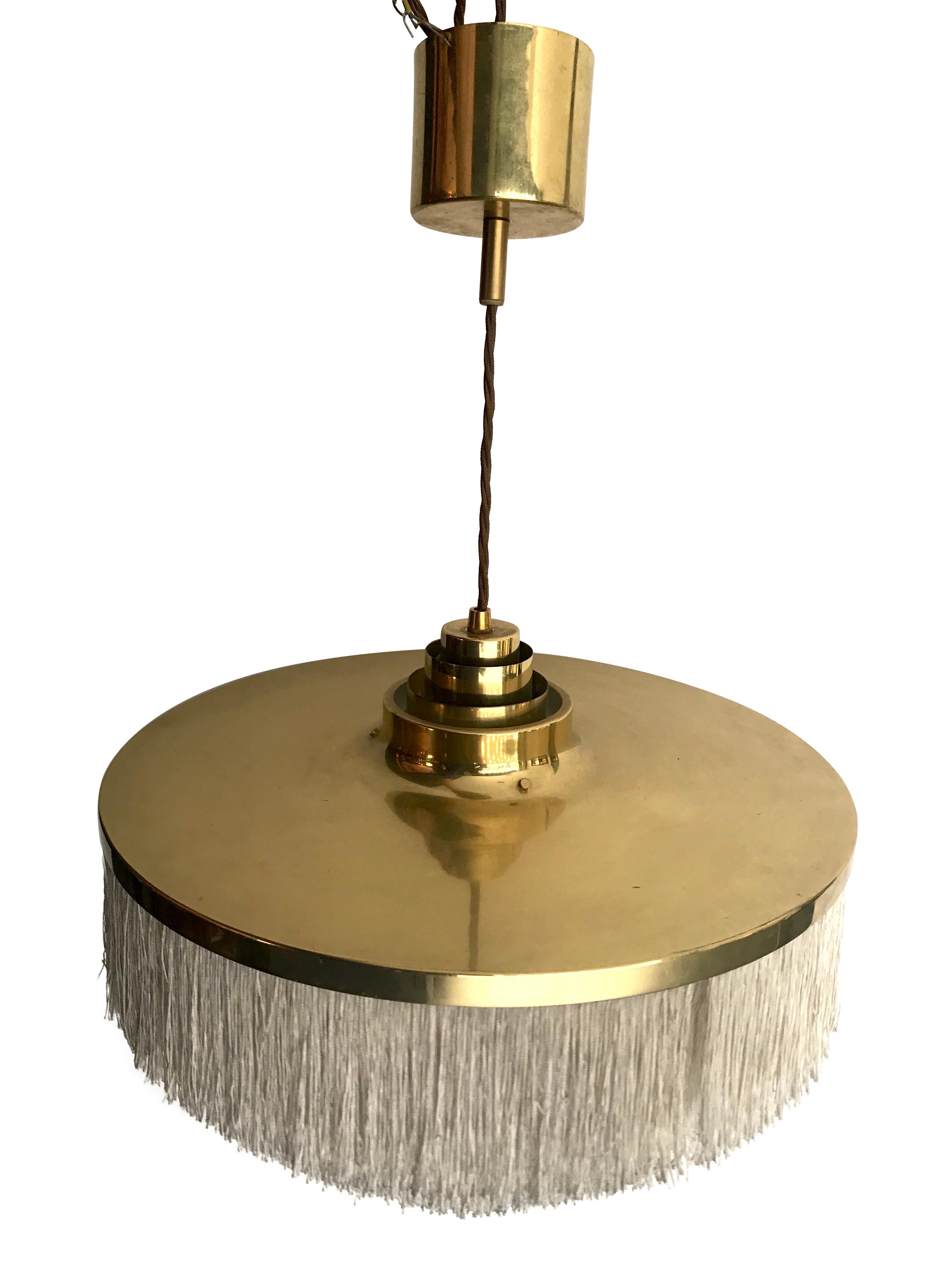 A Hans-Agne Jakobsson fringed pendant light, model T-603 for AB Markaryd, Sweden. The light has five tiers of ivory silk fringing suspended from the brass top shade, with brass ceiling mount.
Re wired with antique gold cord flex. Dimensions listed