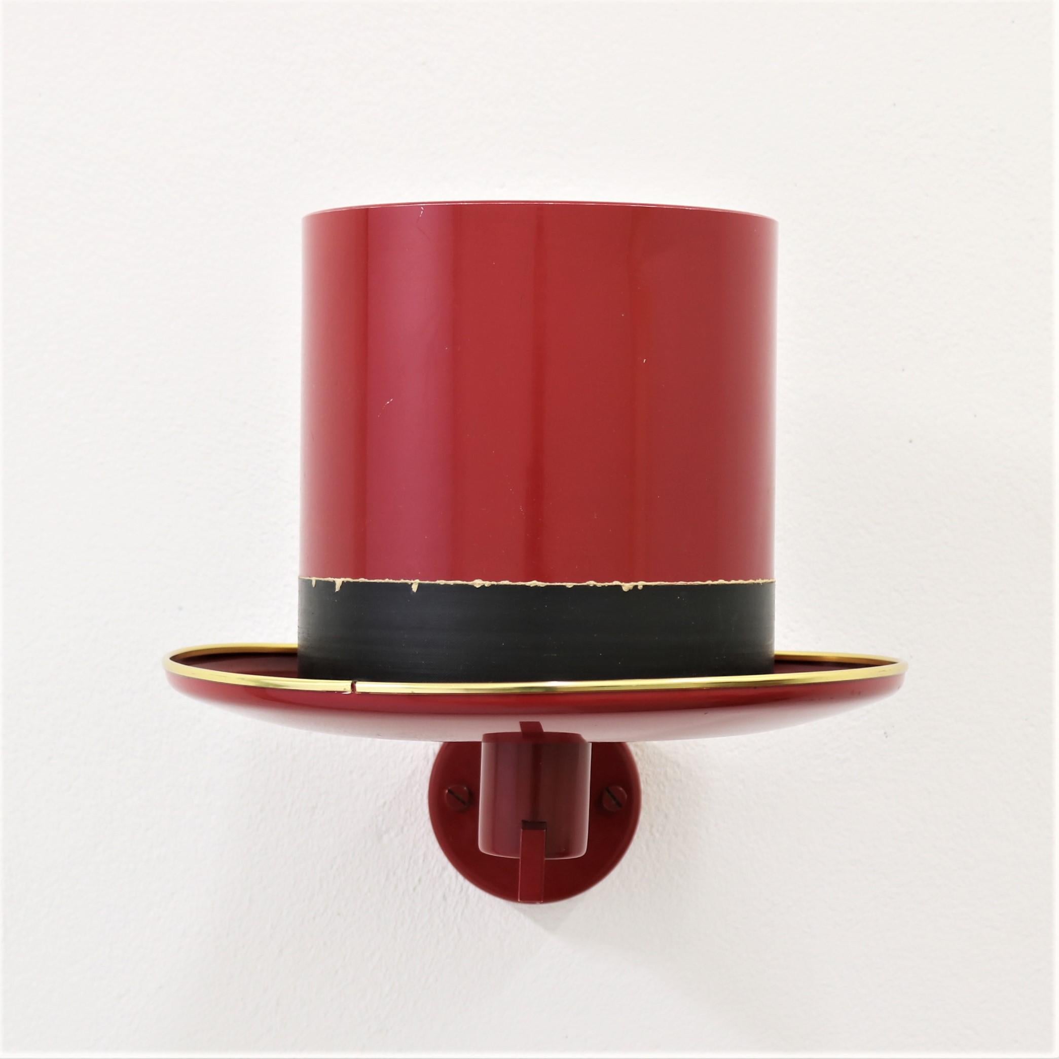 Swedish designer Hans Agne Jakobsson was a very versatile man and this is one of his most extravagant designs. A pair of cool wall sconces made of wine red lacquered brass in the shape of hats. Made for Markaryd, Sweden in the 1960s. All original