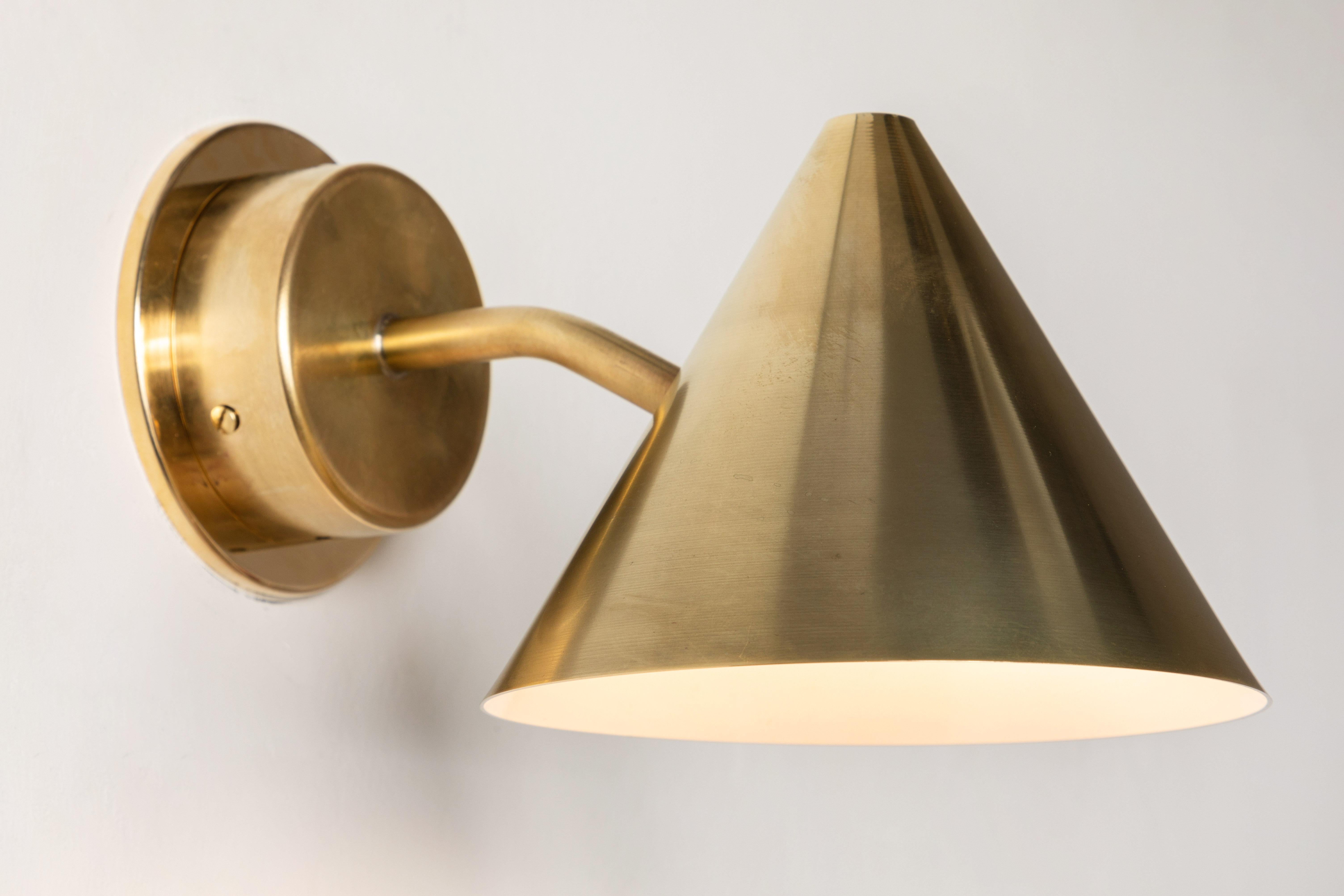 Hans-Agne Jakobsson 'Mini-Tratten' raw brass outdoor sconce. An exclusive made for U.S. and UL listed authorized re-edition of the classic Swedish design executed in raw brass with white painted interior. An incredibly refined design that is