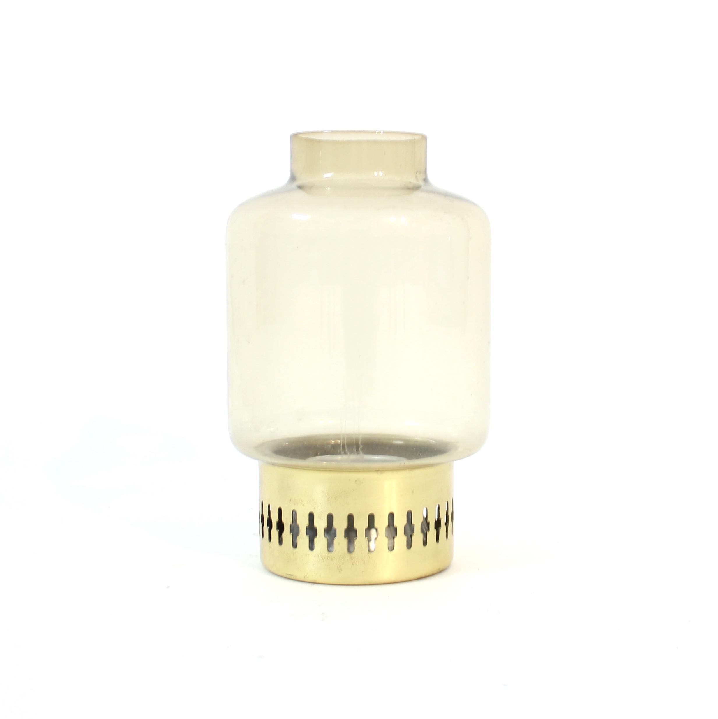 Candle holder, model L 95, designed by Hans-Agne Jakobsson for his own company  Hans-Agne Jakobsson AB, Markaryd, in the 1960s. It contains a smoke coloured glass bulb on a brass base. Very good vintage condition with light ware consistent with age