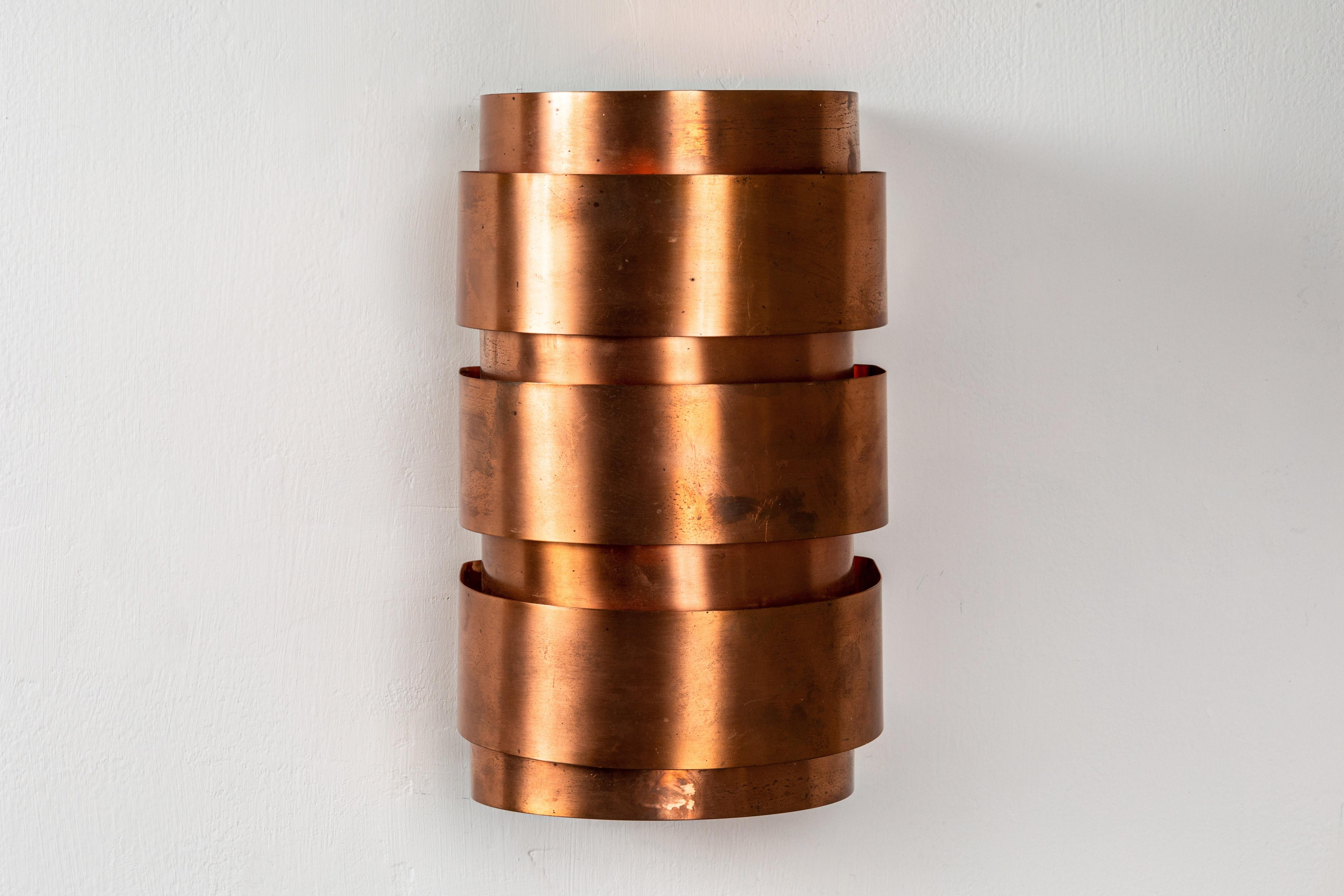 Hans-Agne Jakobsson model V-155 copper sconces for Markaryd, Sweden. Executed in copper, this incredibly refined design is quintessentially Scandinavian.

Price is for the pair.

Professionally rewired for US electrical with custom modified