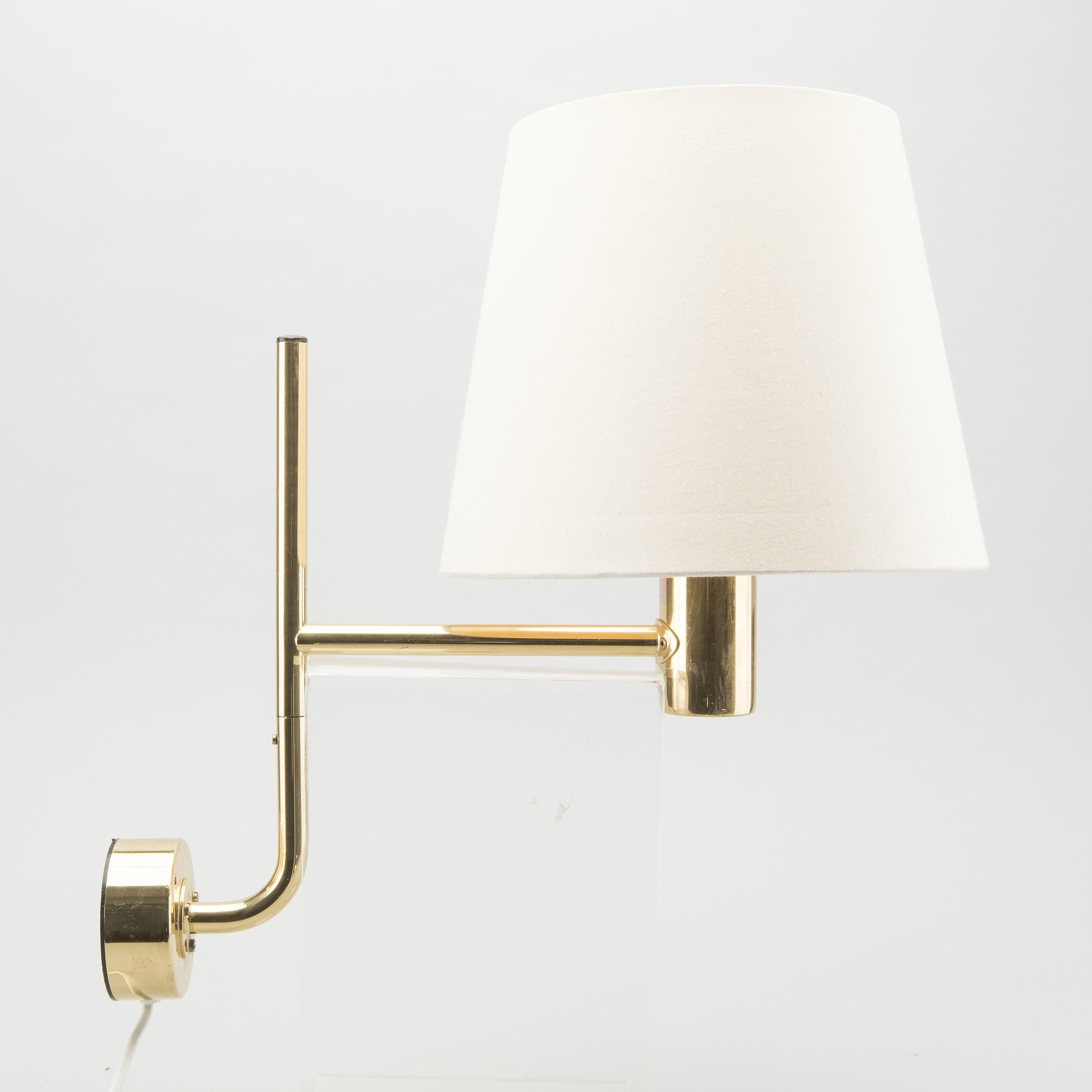 A pair of wall lights by Hans-Agne Jakobsson, brass with cream shades. Shades and brass show wear consistent with age. Labels at bottom of fixtures.
Can be rewired upon request.