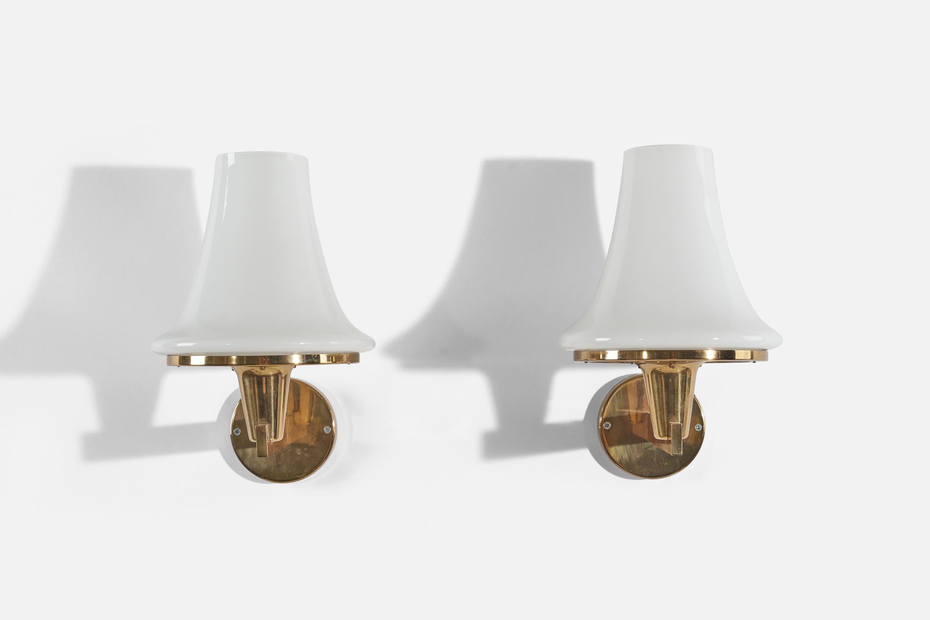 A pair of brass and milk glass wall lights designed by Hans-Agne Jakobsson and produced by his own firm in Markaryd, Sweden. c. 1960s.

Dimensions of the back plate (inches) : 4.375 x 4.375 x .1875 (H x W x D)
Does not come with screws.
 
